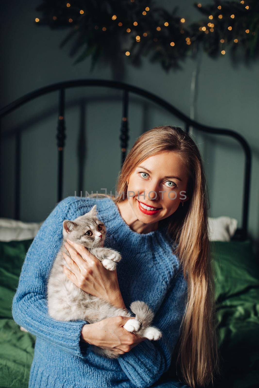 A woman with a cat hugs at home