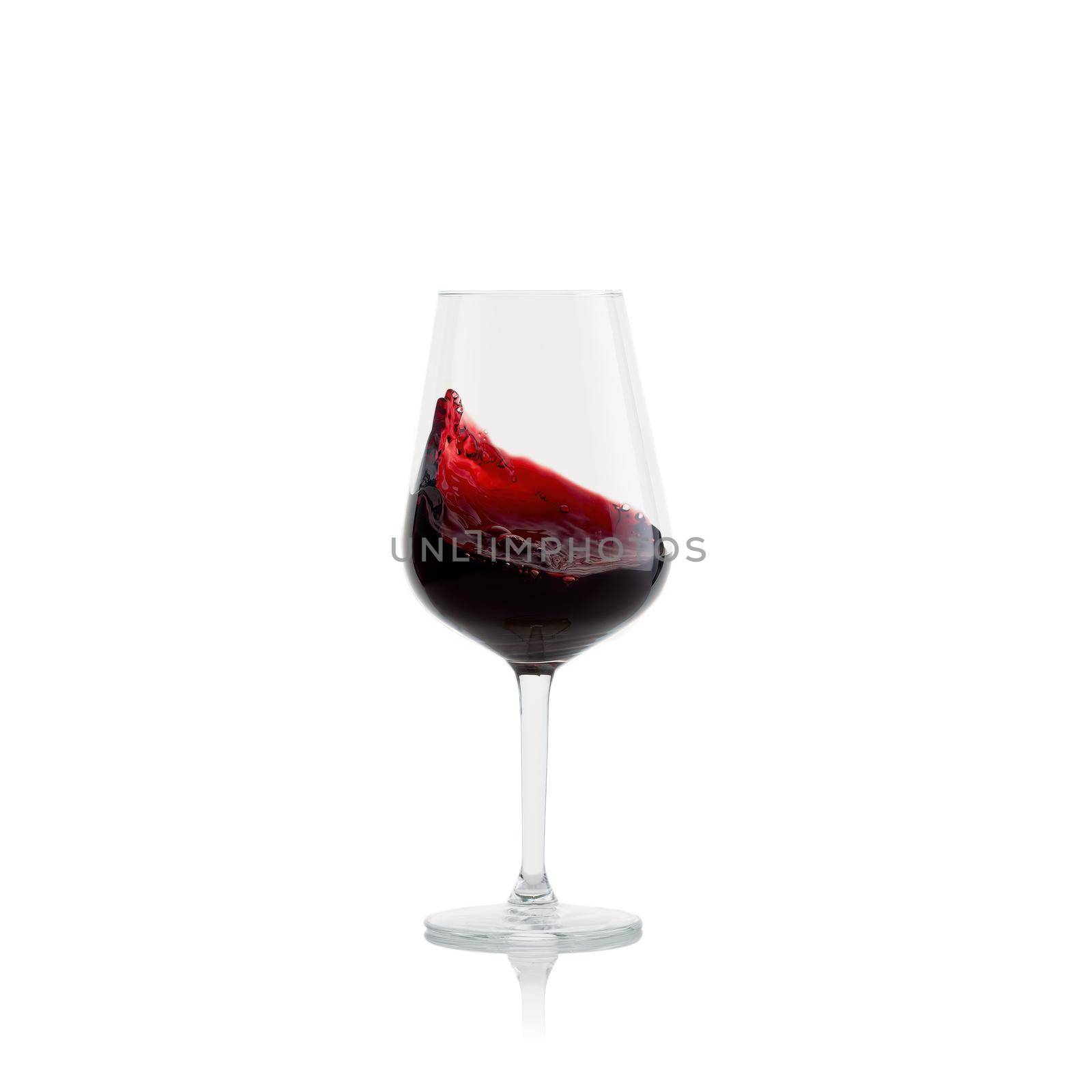 Tasty Red Wine with splash in glass isolated on white background.