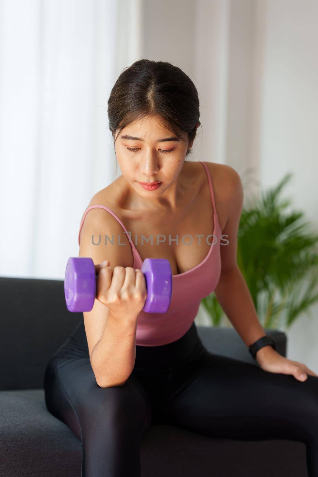 Beautiful woman exercising with dumbbells at home. bodybuilding, fitness, sport, weightlifting concept