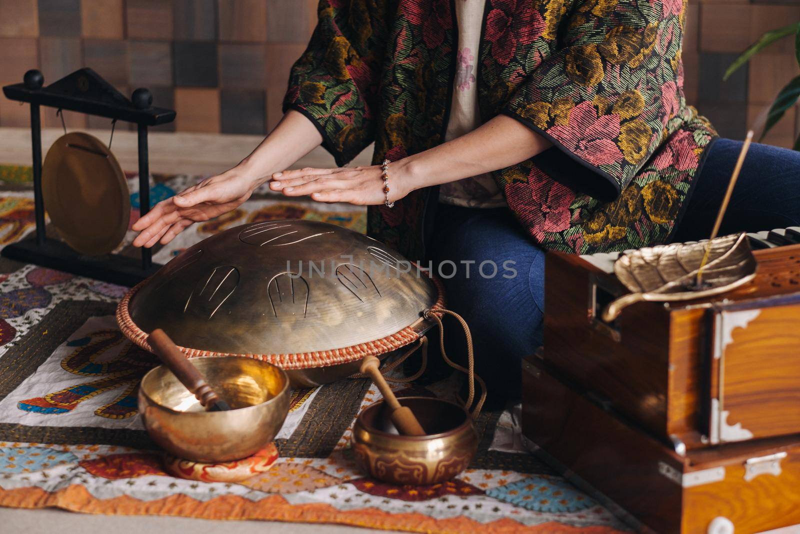 Close-up of a woman's hand playing a modern musical instrument - the Orion reed drum.