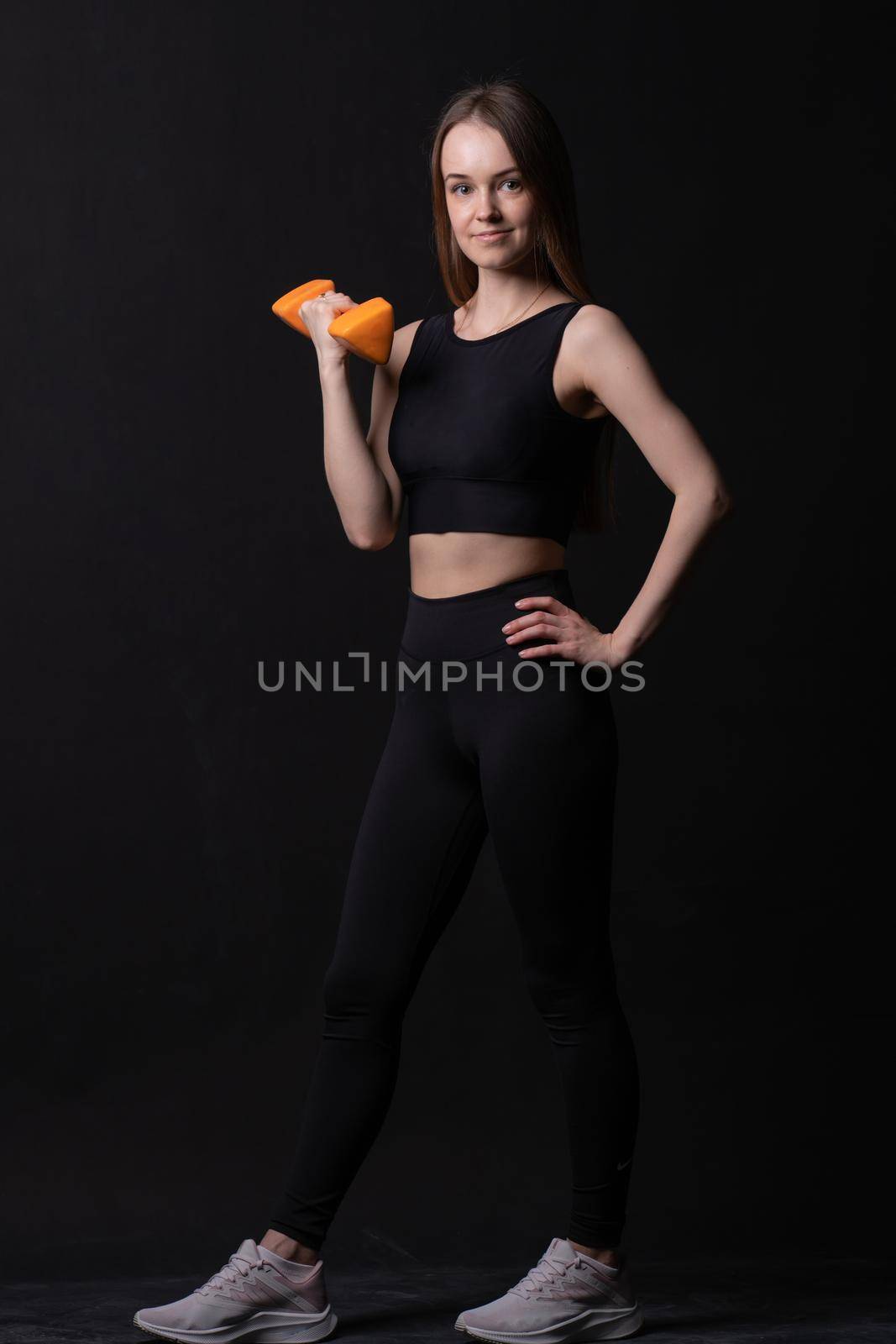 Orange . Beautiful black on maiden background dumbbells with a orange two white, for shape body in fit and weight diet, happy loss. Chubby physical cheerful, arms young overweight doing