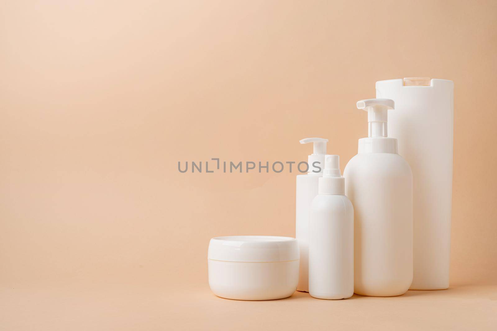 Eco friendly shopping and living.Group of white blank packaging tubes and containers for cosmetics on beige natural color background, mockup design, eco friendly