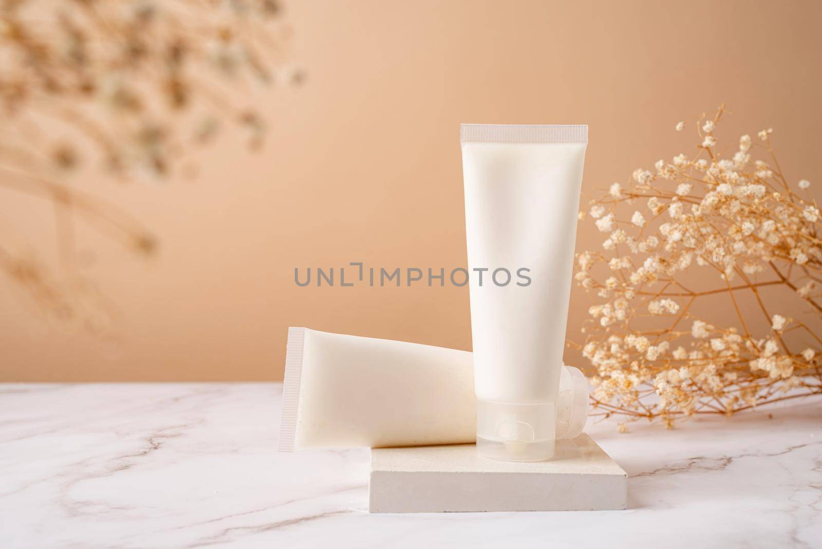 Cream tube mockup for branding presentation. Natural skincare beauty product on square white podium. Natural earthy colors, beige background