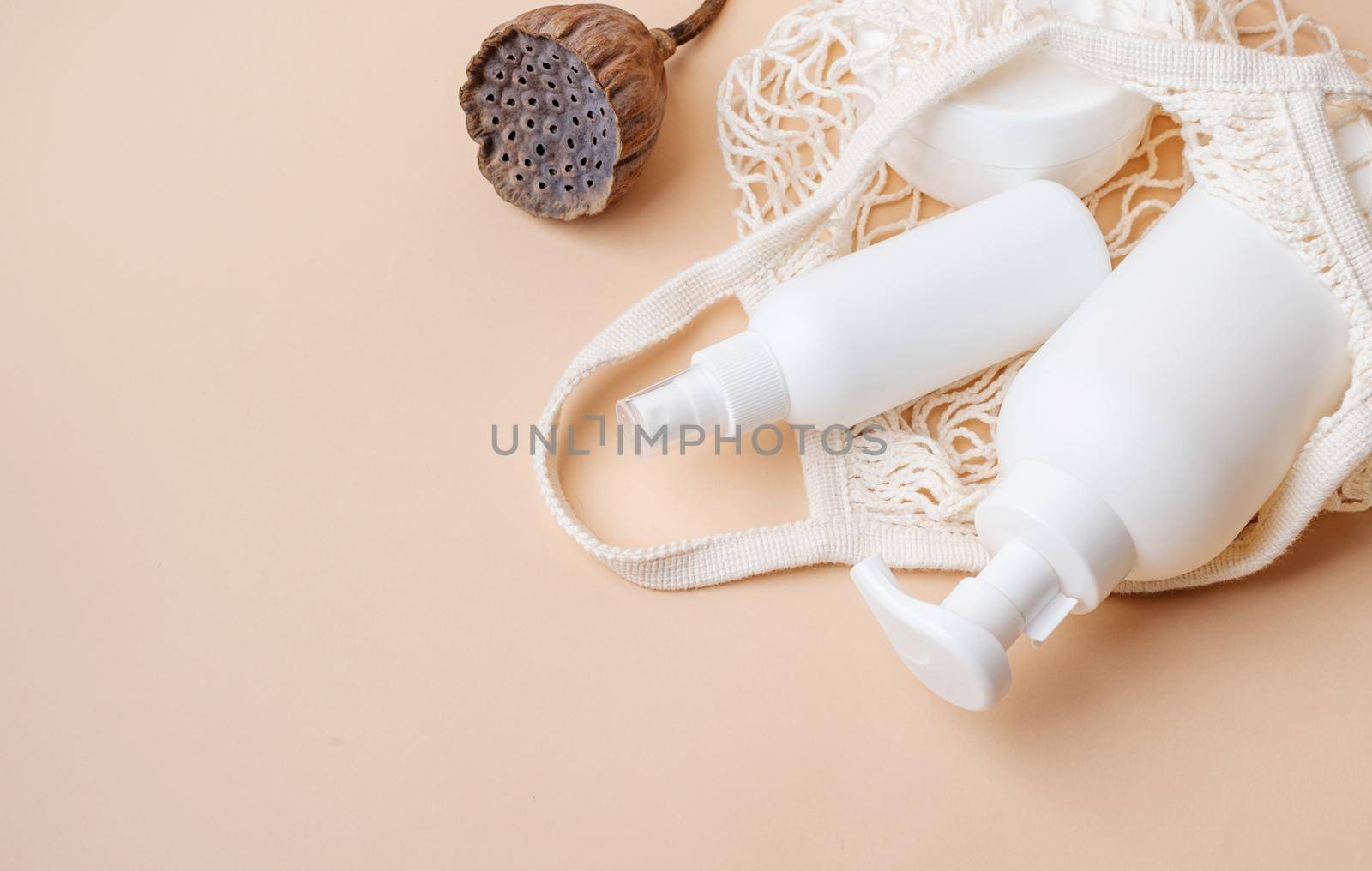 Eco friendly shopping and living. Natural skincare beauty product in mesh bag on beige backdrop. Natural earthy colors, beige background, minimal design