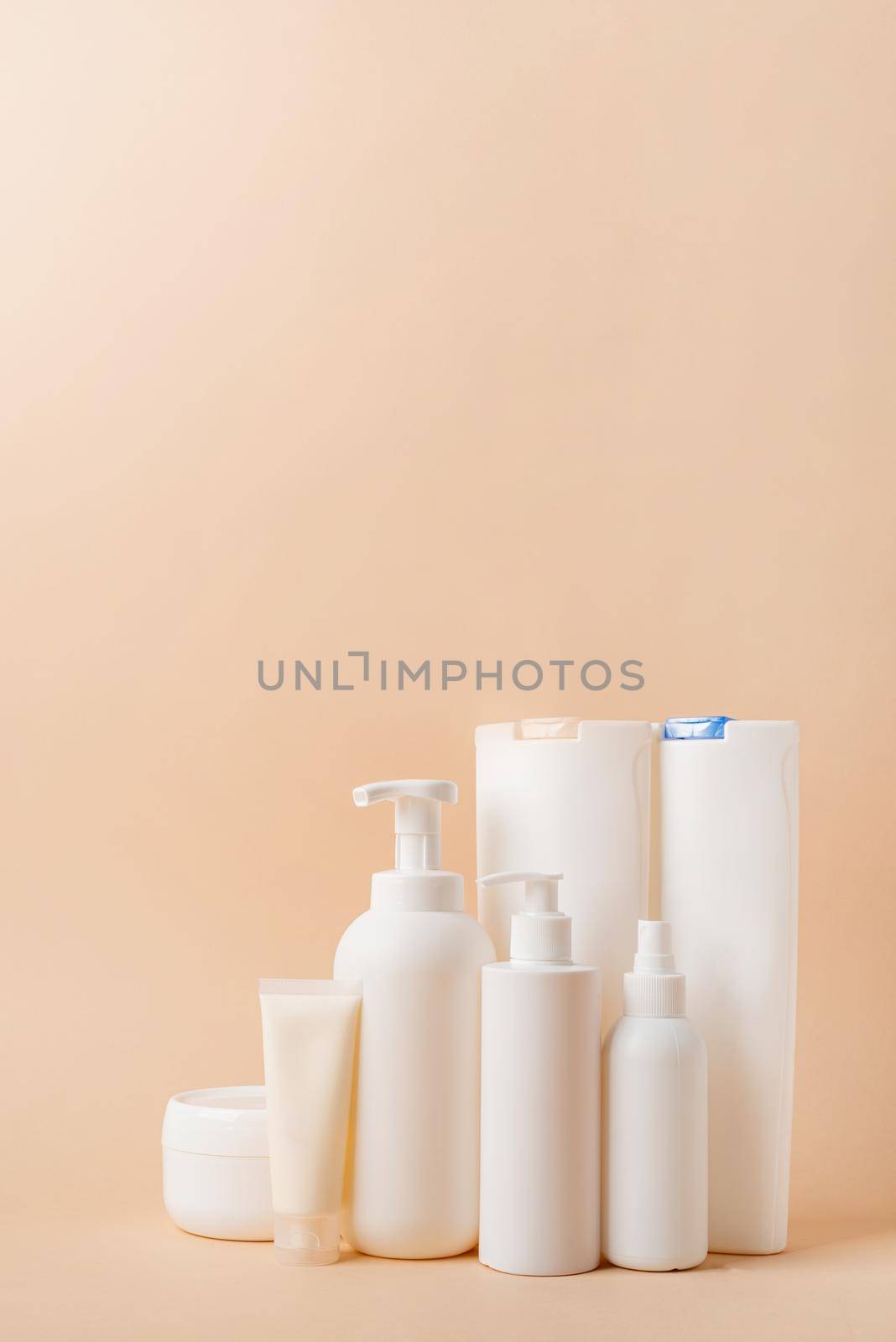 Eco friendly shopping and living.Group of white blank packaging tubes and containers for cosmetics on beige natural color background, mockup design, eco friendly