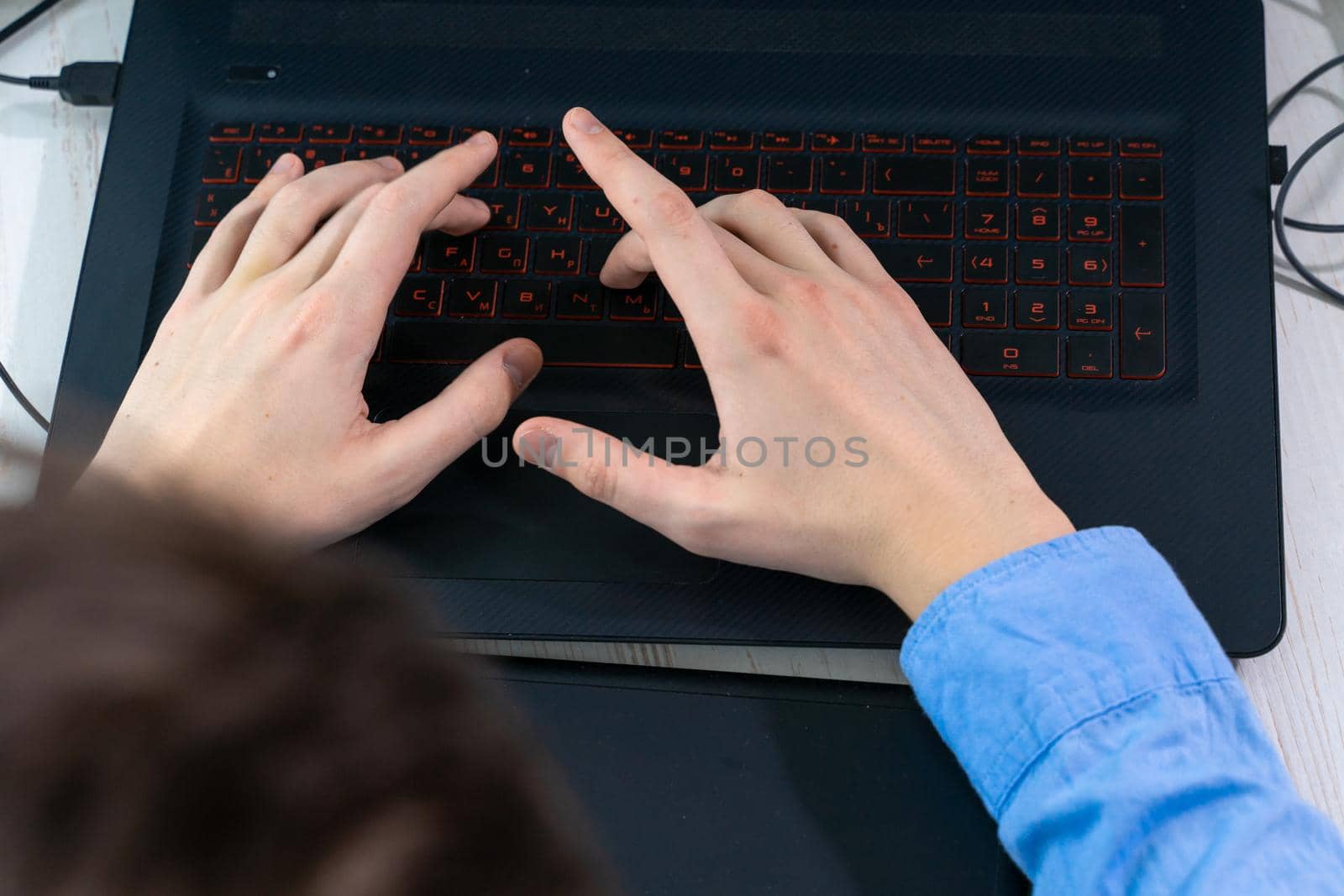 Man Typing on Laptop Keyboard, close-up.