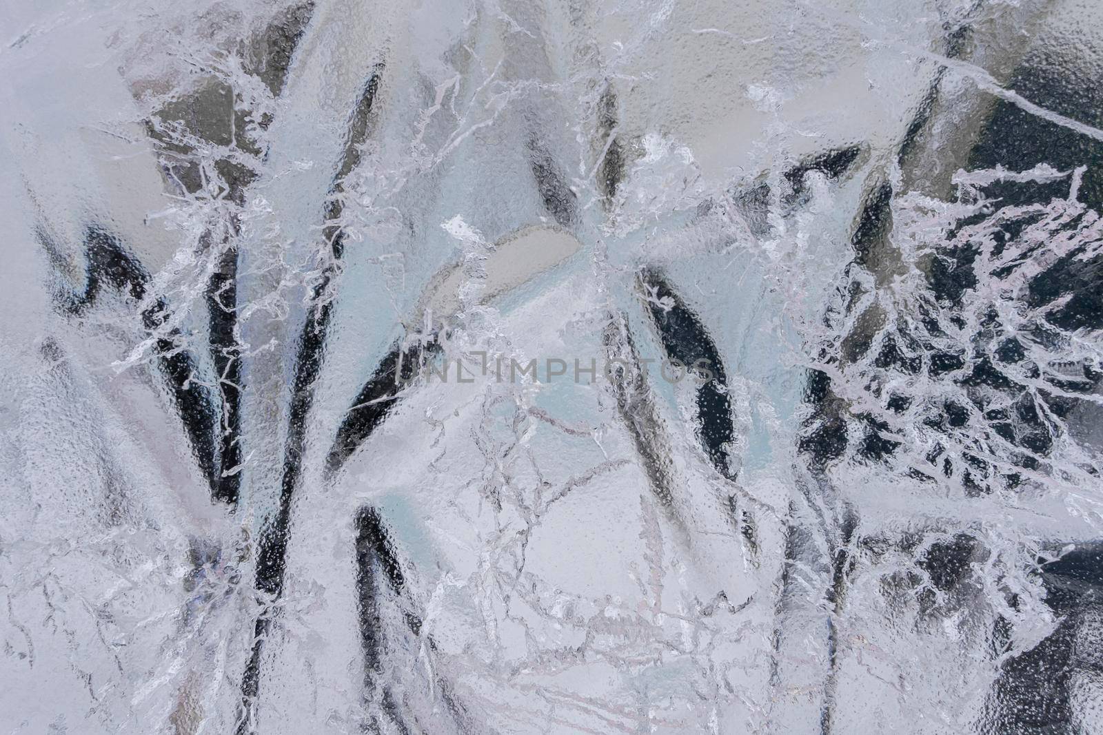 Beautiful blue ice of Lake with abstract cracks