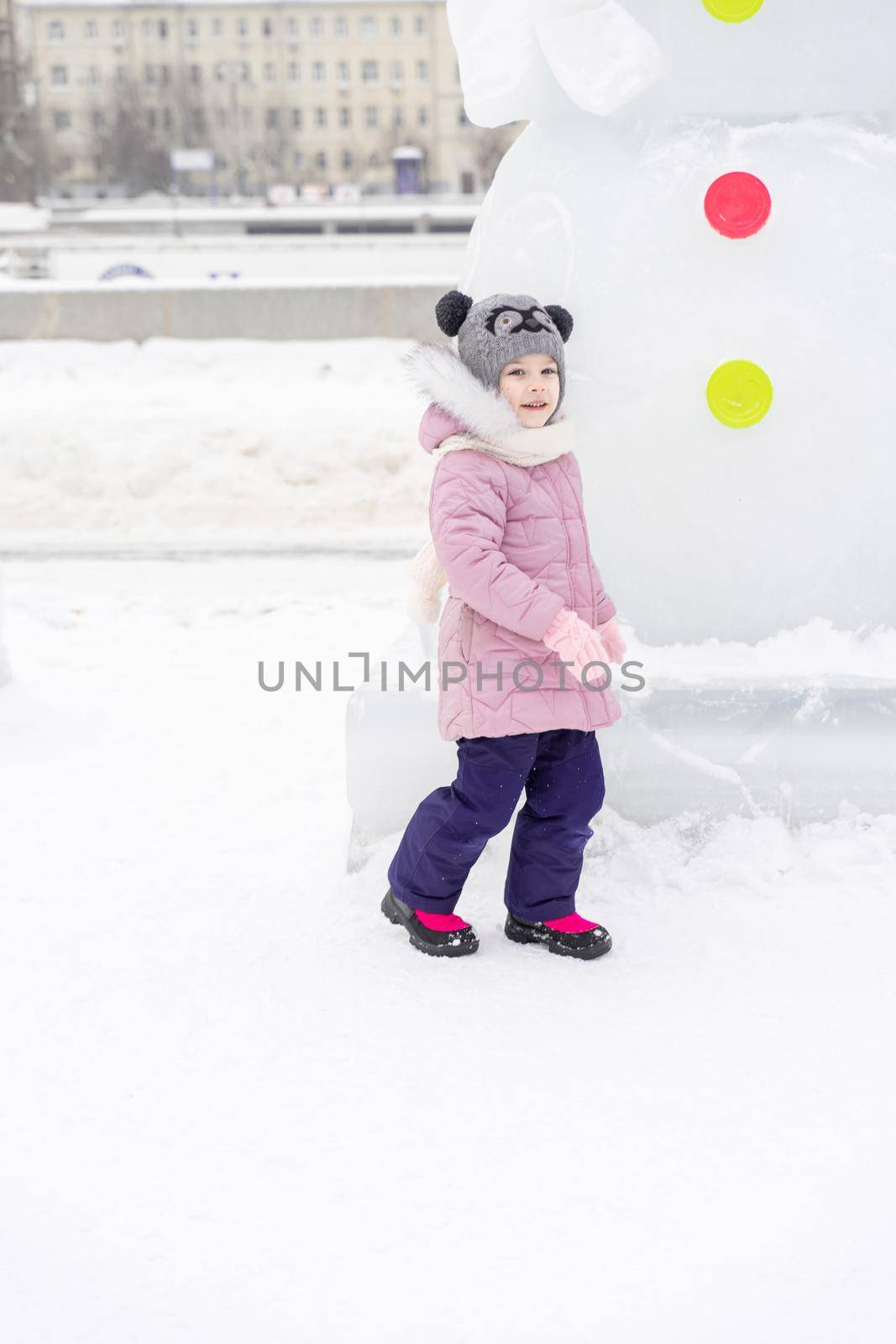 playful child girl happy in snow town on winter day by Lena_Ogurtsova