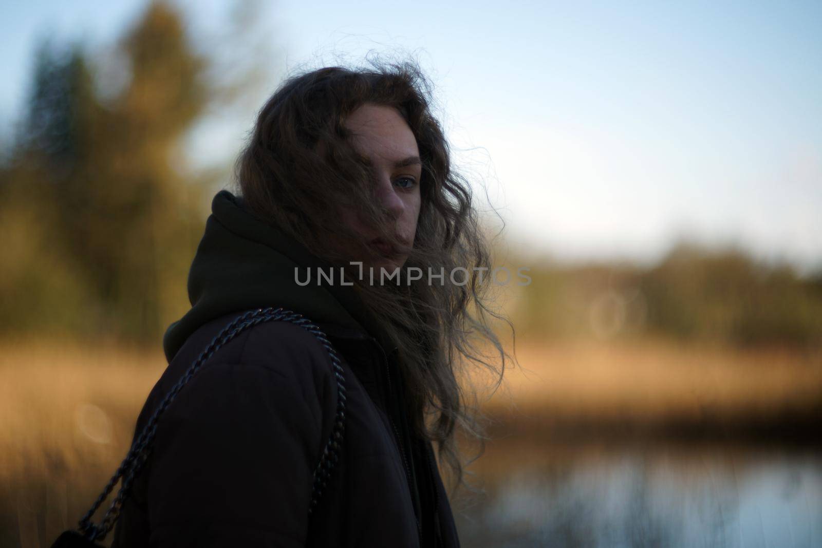 beautiful young woman with an anxious look. girl with strands of facial hair.