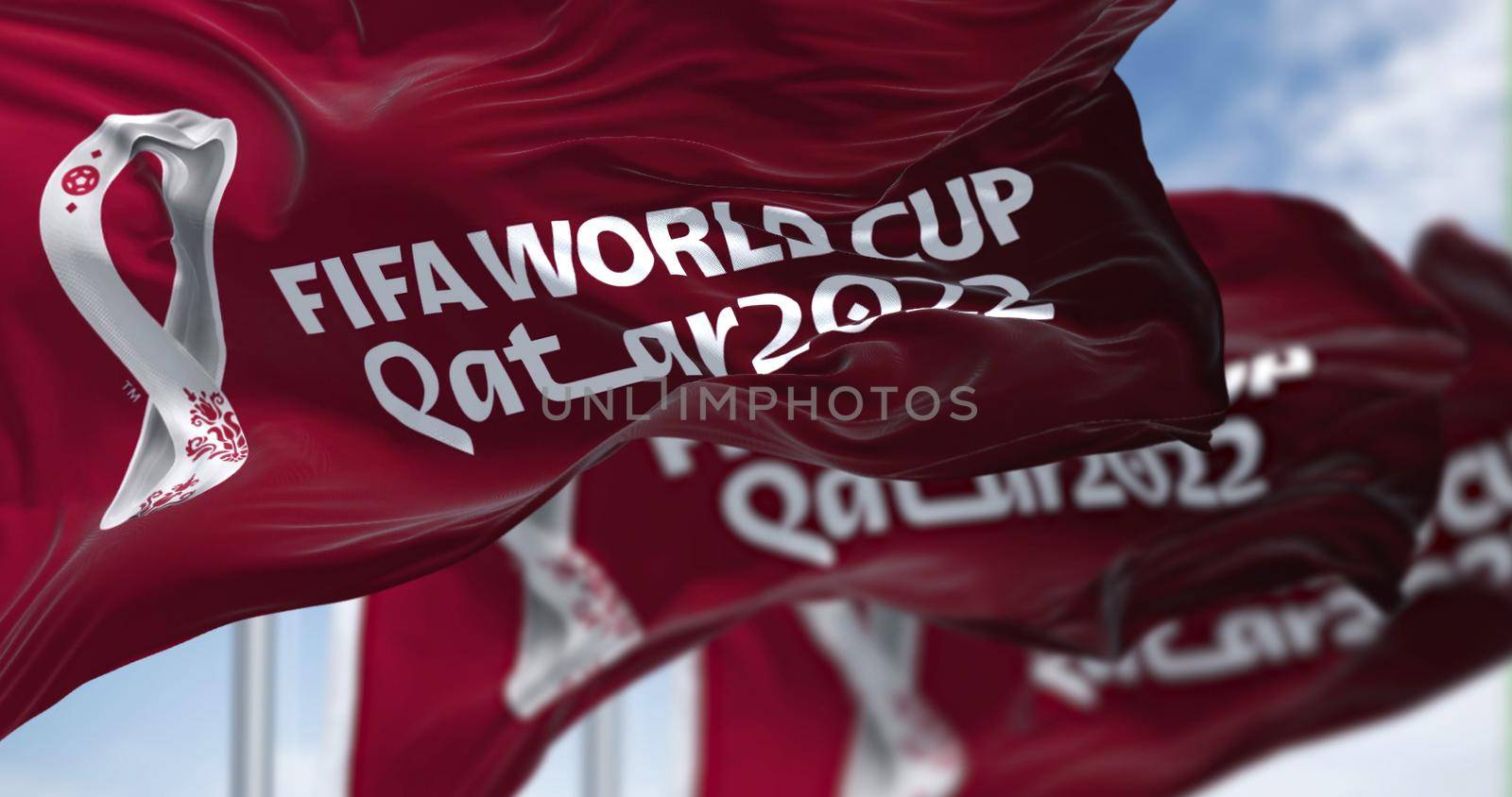 Doha, Qatar, April 2022: Flag with the Qatar 2022 Fifa World Cup logo flapping in the wind by rarrarorro