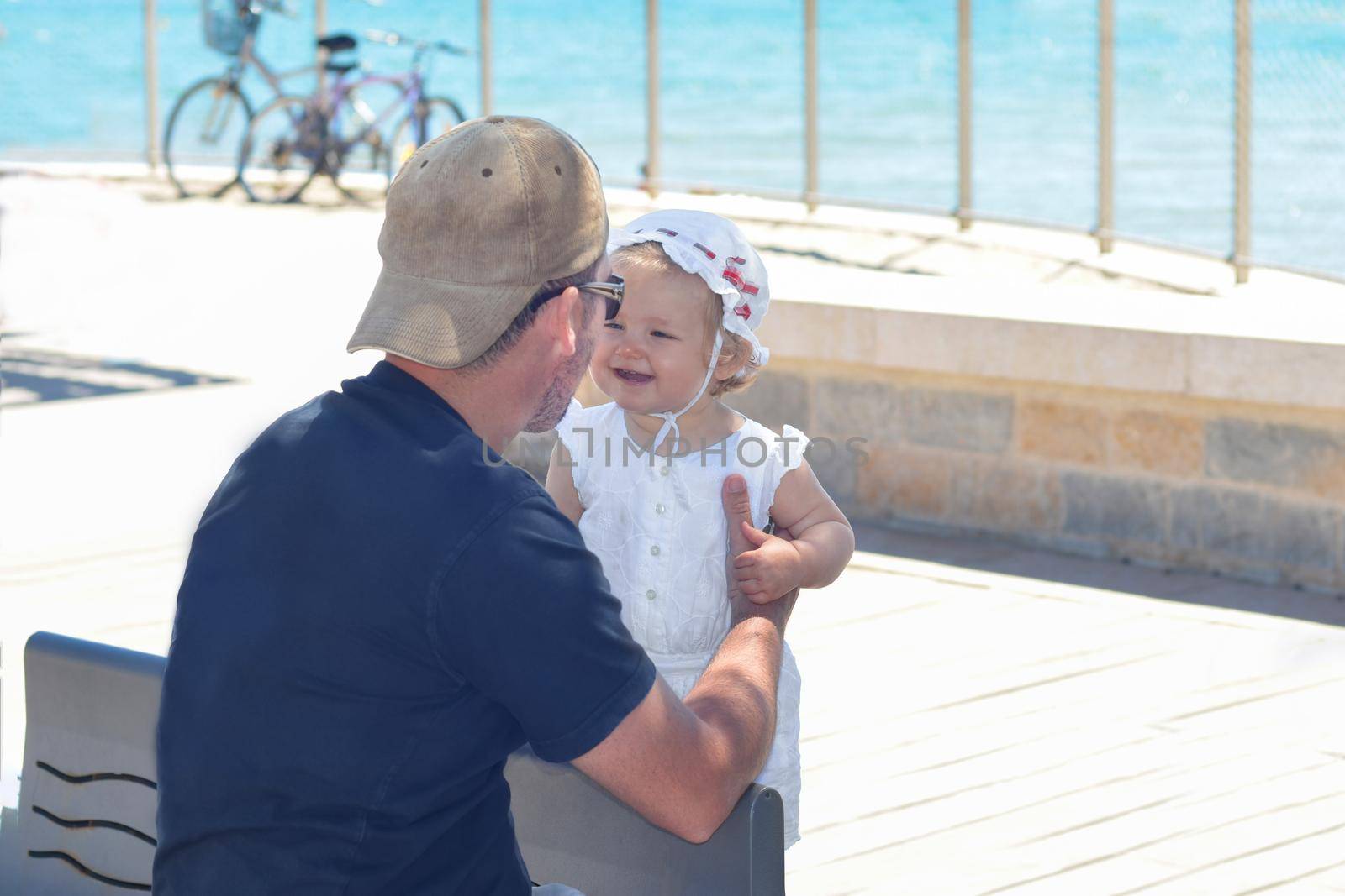 Father and daughter smiling at the seaside