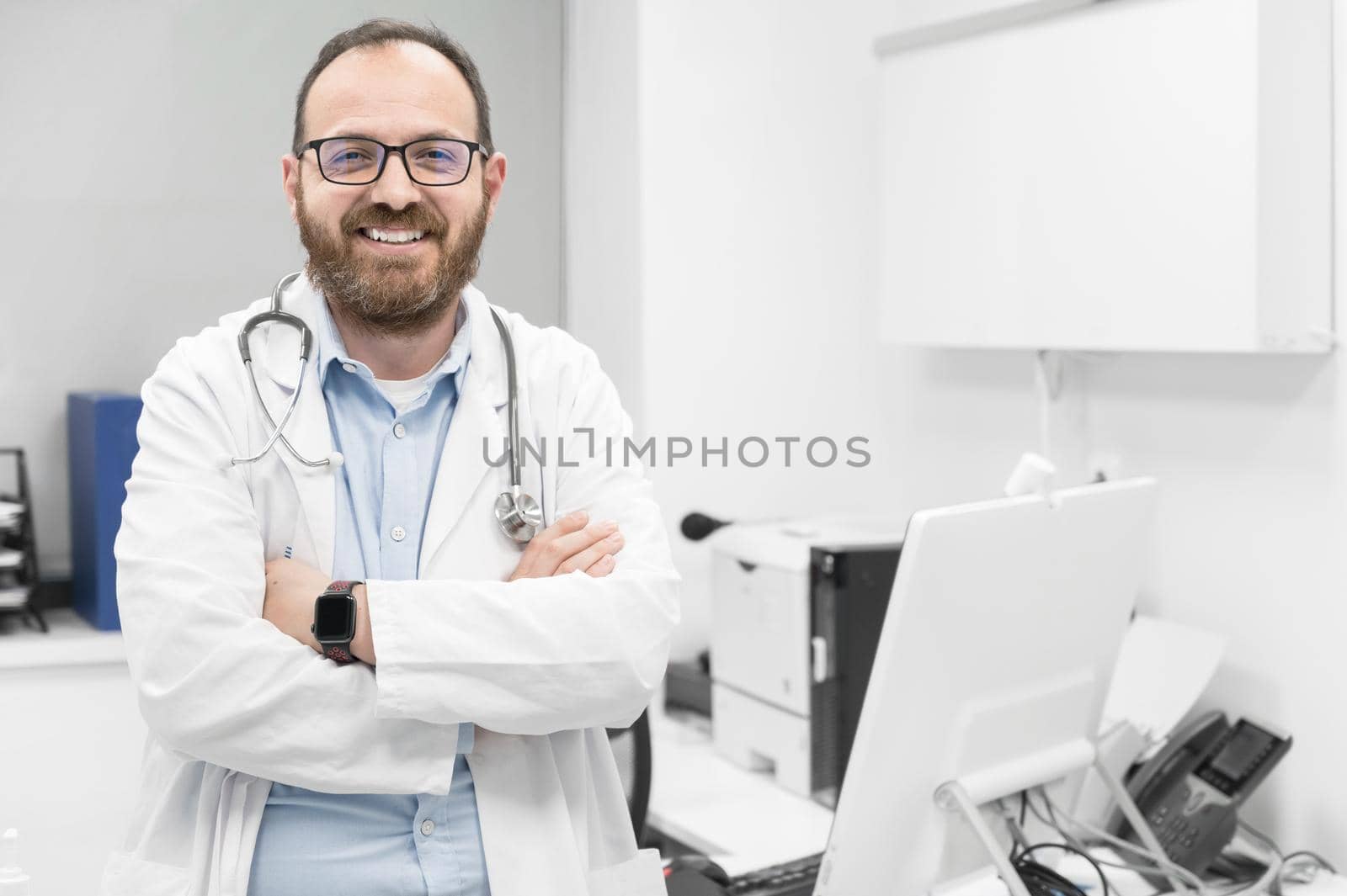 Portrait of confident doctor crossing hands and smiling at camera. by HERRAEZ