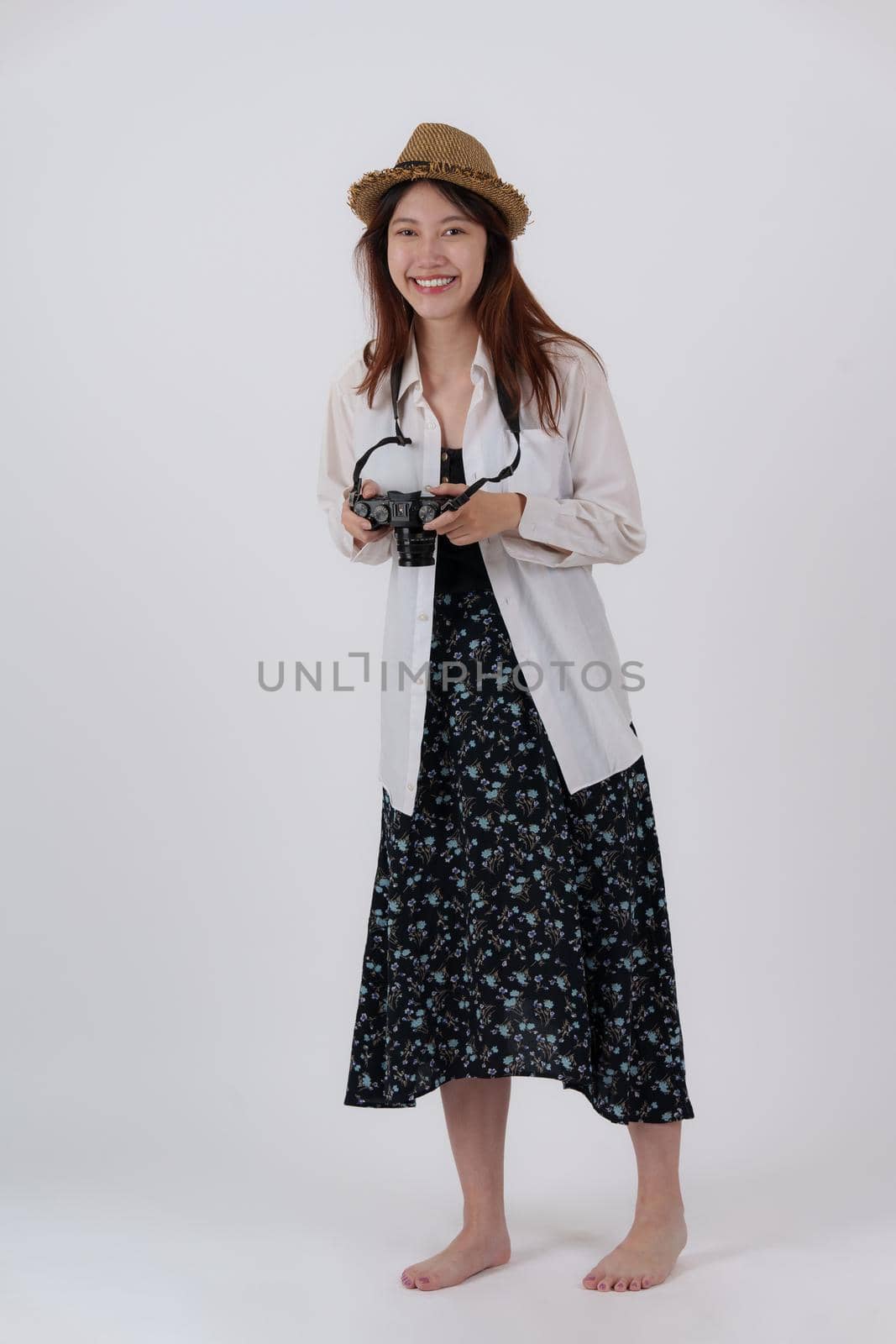 Image of happy young woman with camera isolate over white background. Travel and Summer concept