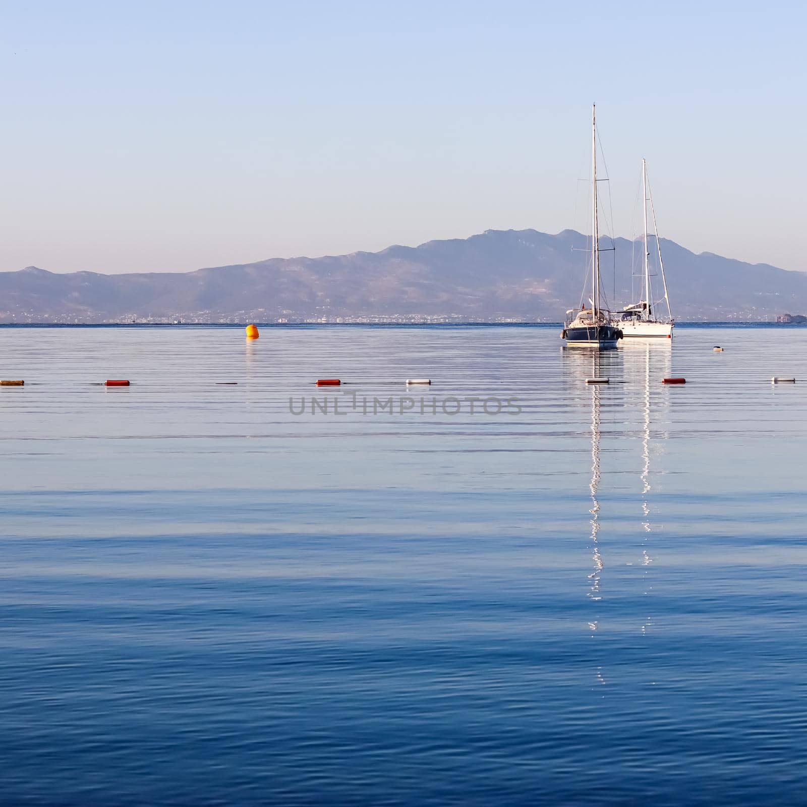Blue sea, boats, mountains and islands on the Aegean coast. Summer vacation and coastal nature concept