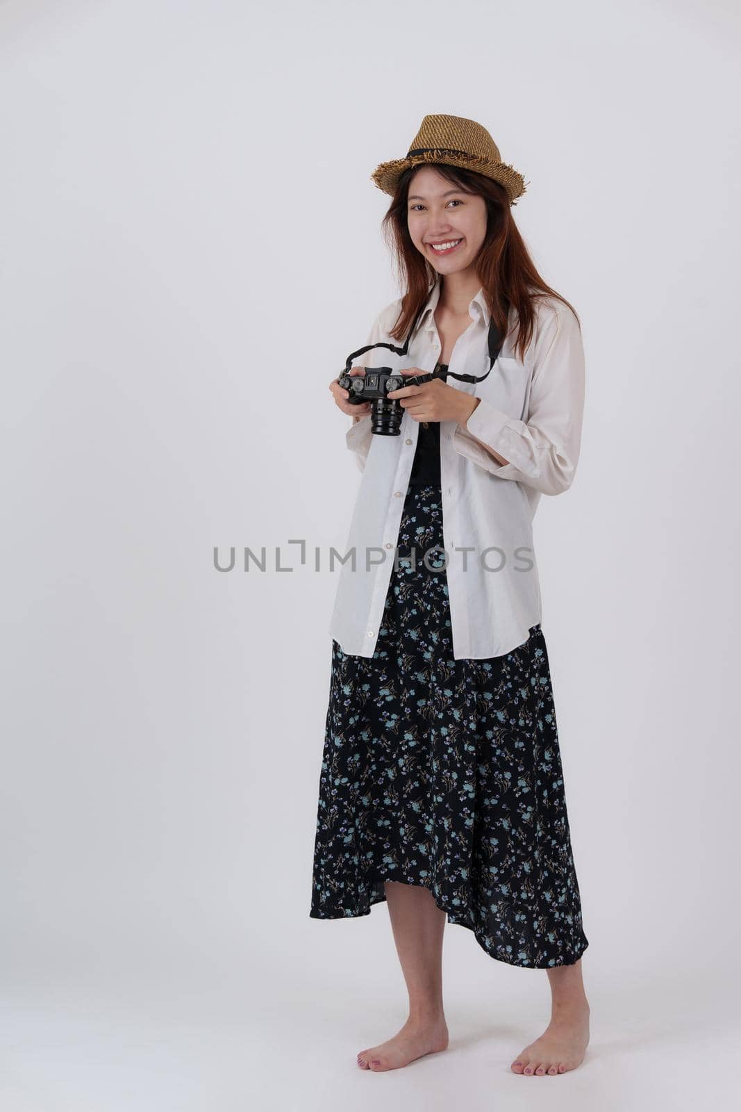 Image of happy young woman with camera isolate over white background. Travel and Summer concept