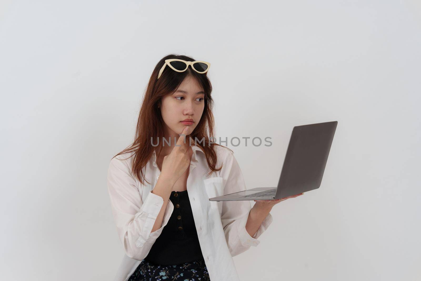 Charming woman working with laptop computer before summer travel. isolated over white background. by itchaznong