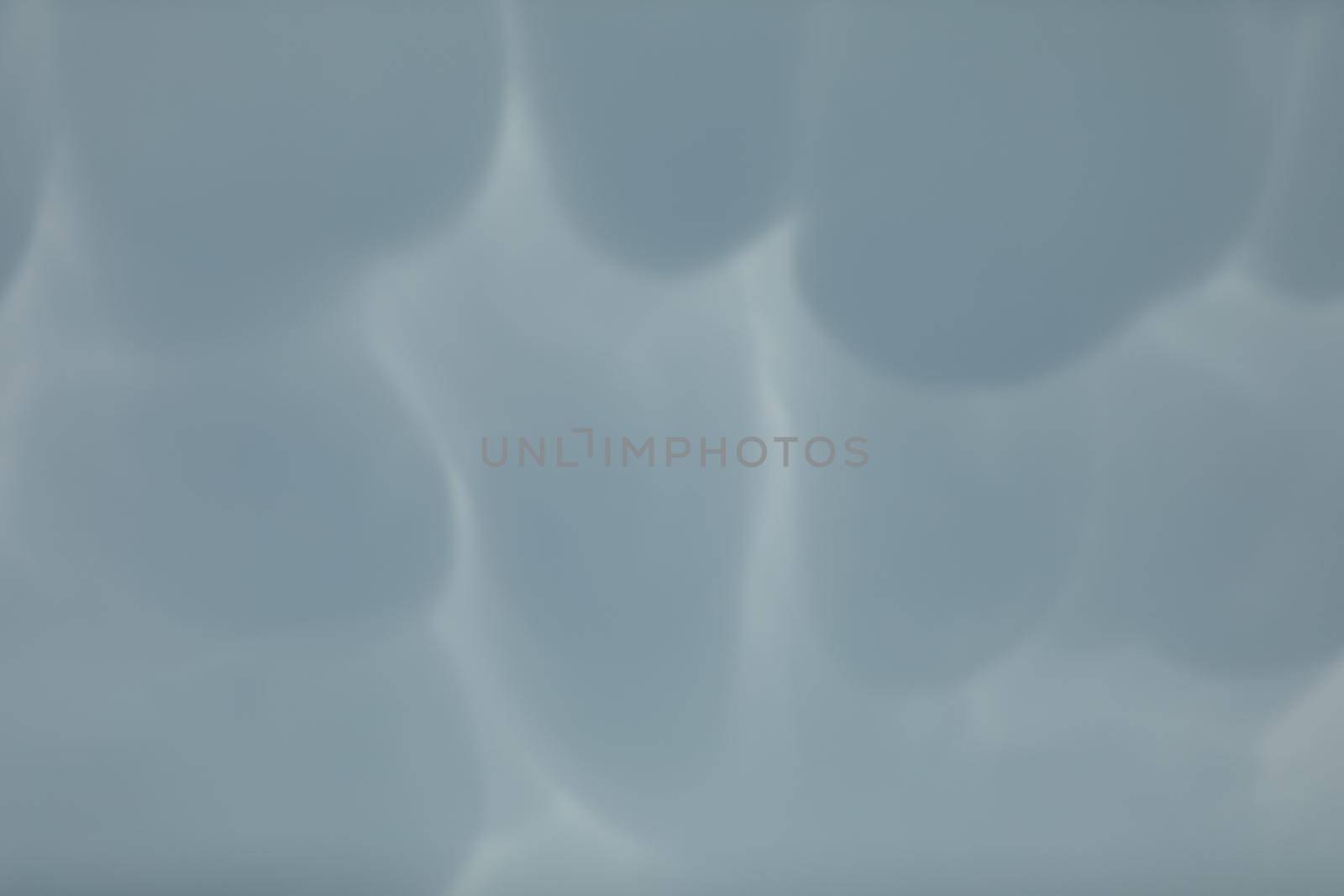 During unusually strong winds, clouds accumulate and gather into irregular bubbles. Close up frame of a slice of the sky.