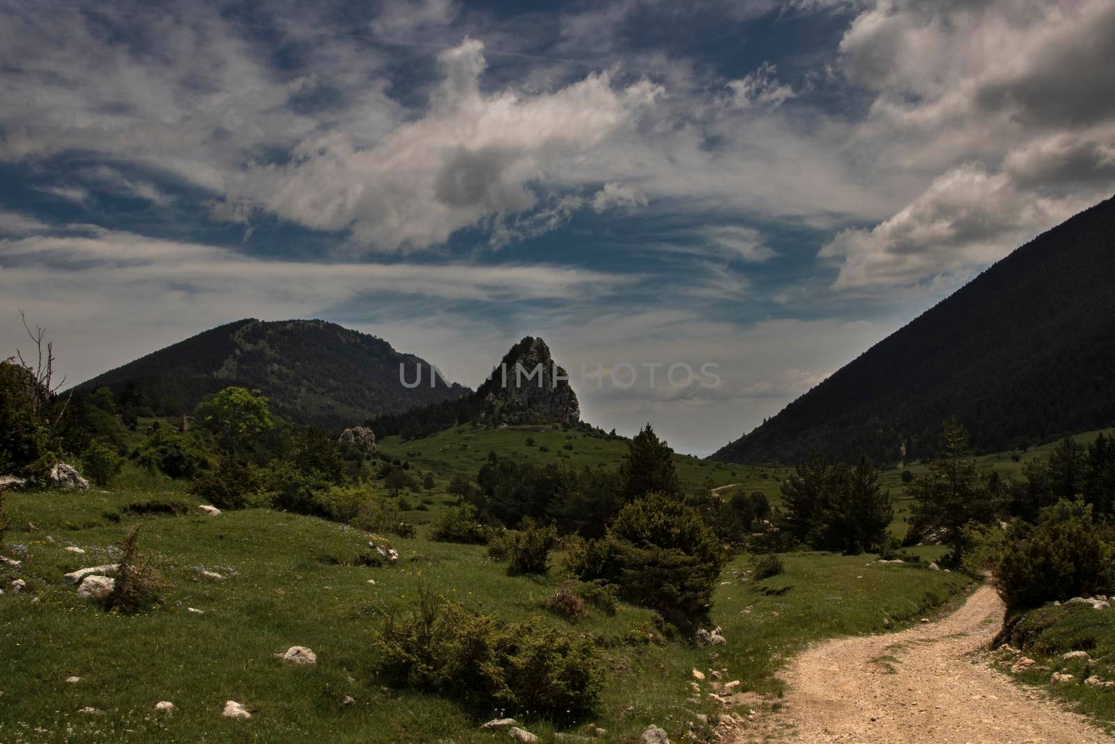 Landscape showing a curved path and some peaks and mountains in Rasos de Peguera in Catalonia