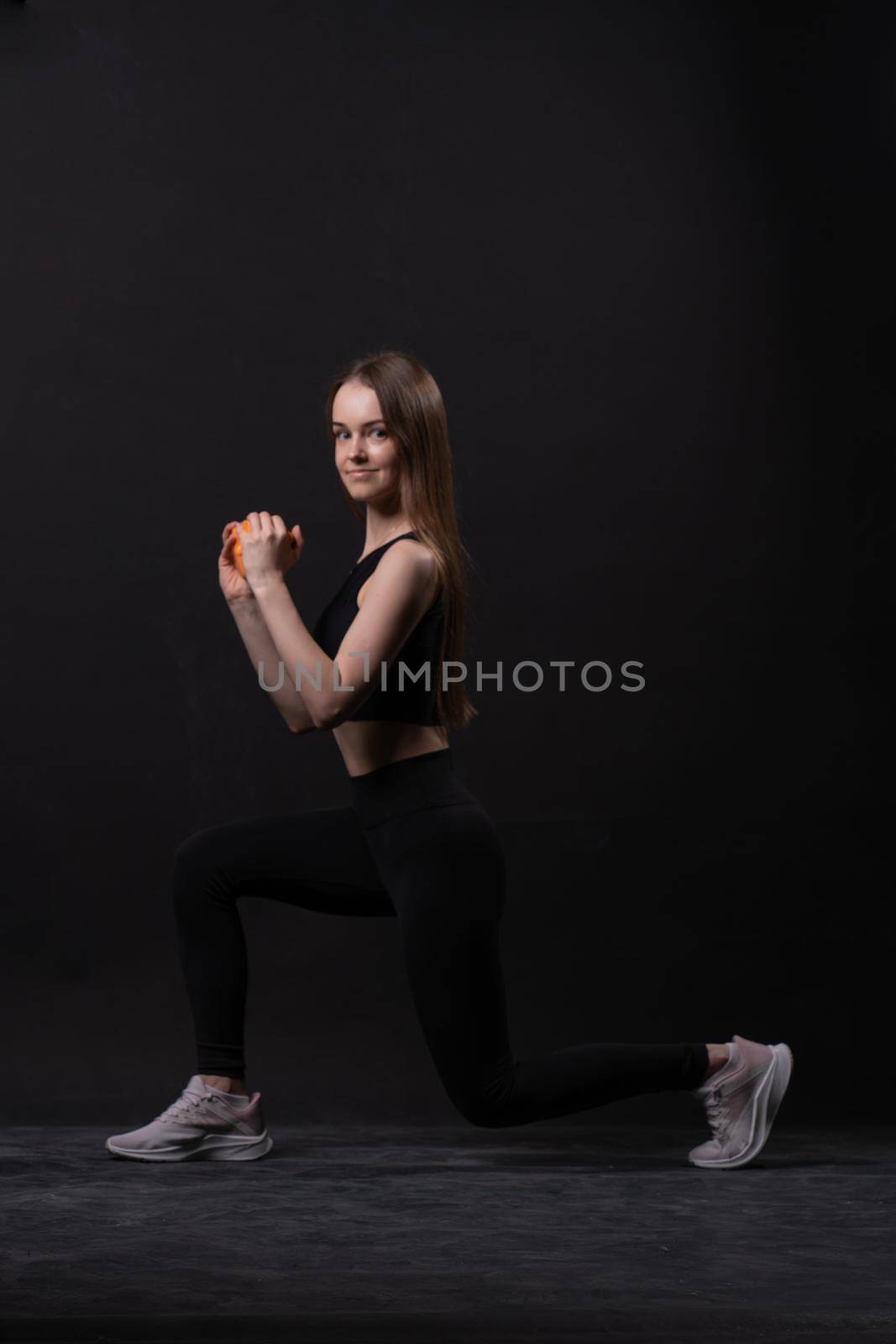 Beautiful on black background with orange maiden dumbbells a . Orange two gym, for shape body from woman and sport diet, happy plus. Chubby physical joy, portrait young overweight doing