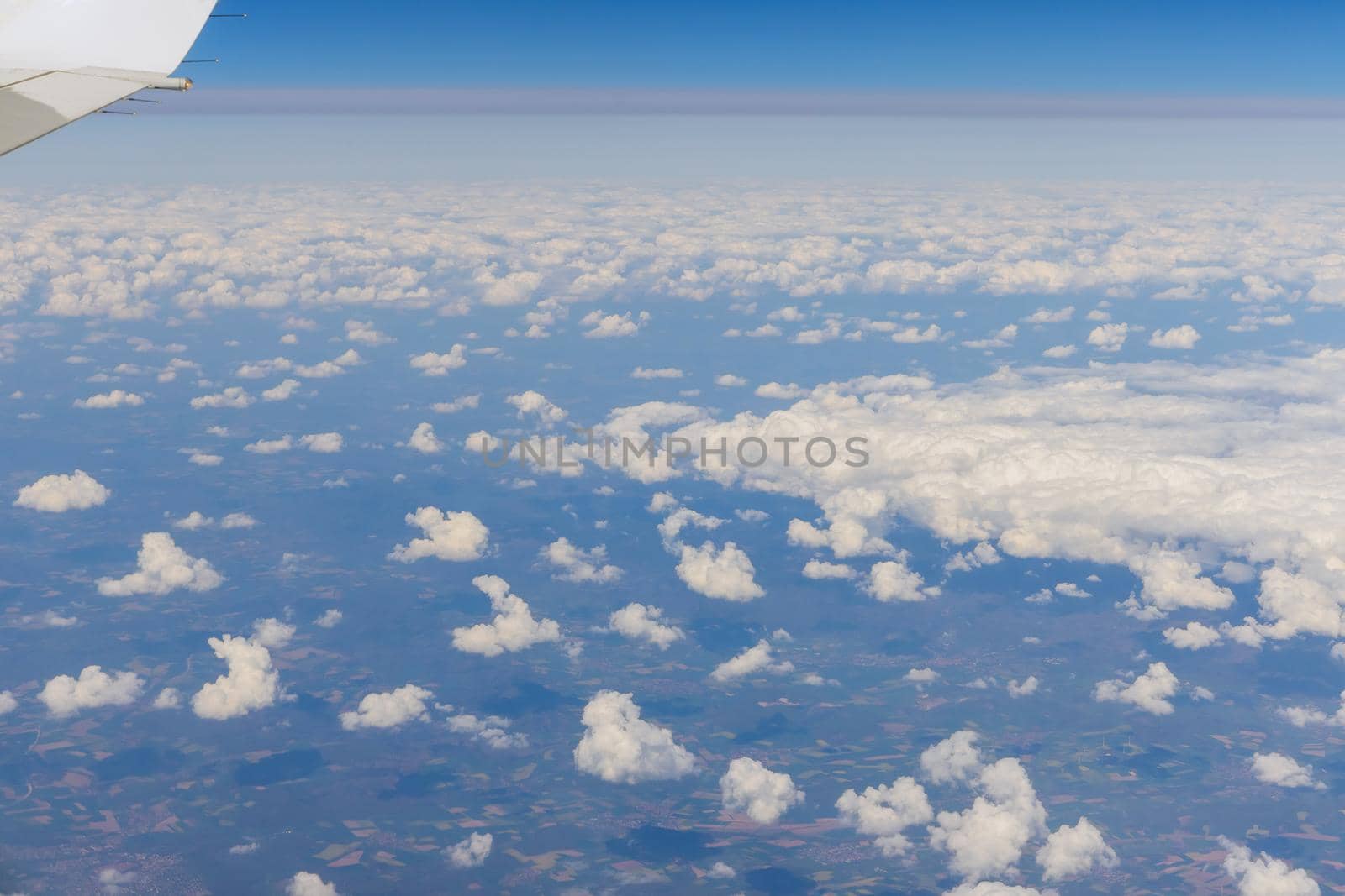 Aircraft view from window on clouds blue sky with flying landscape of the clear sky