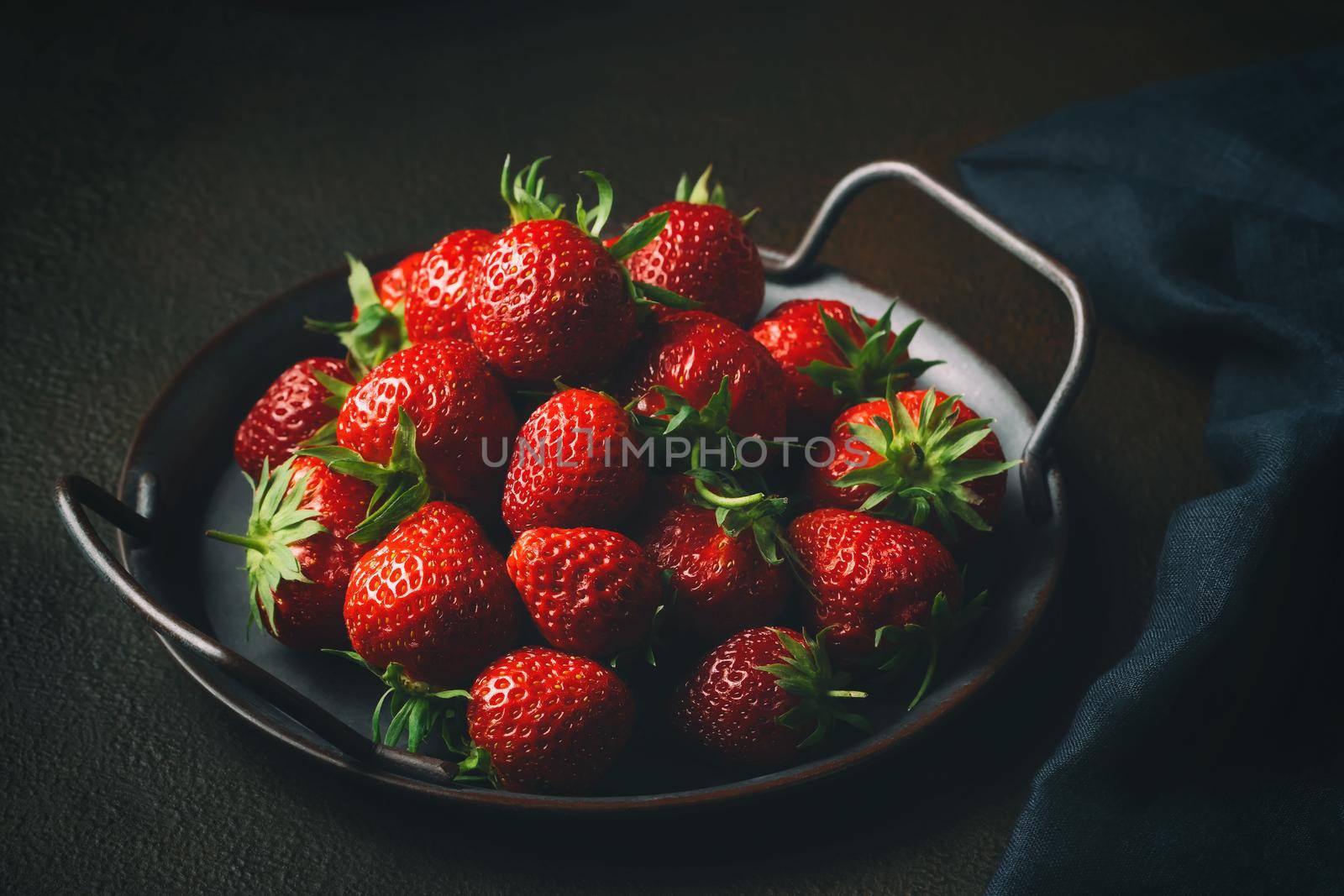 Ripe fresh farmed natural strawberries on a metal tray on the table by galsand