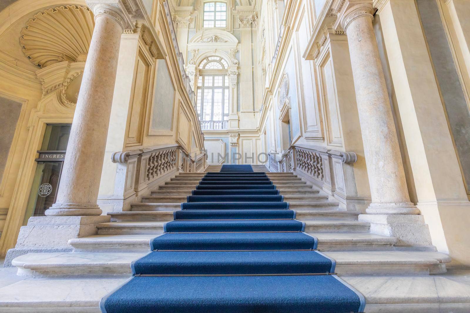 TURIN, ITALY - CIRCA JUNE 2021: The most beautiful Baroque staircase of Europe located in Madama Palace (Palazzo Madama). Interior with luxury marbles, windows and corridors.