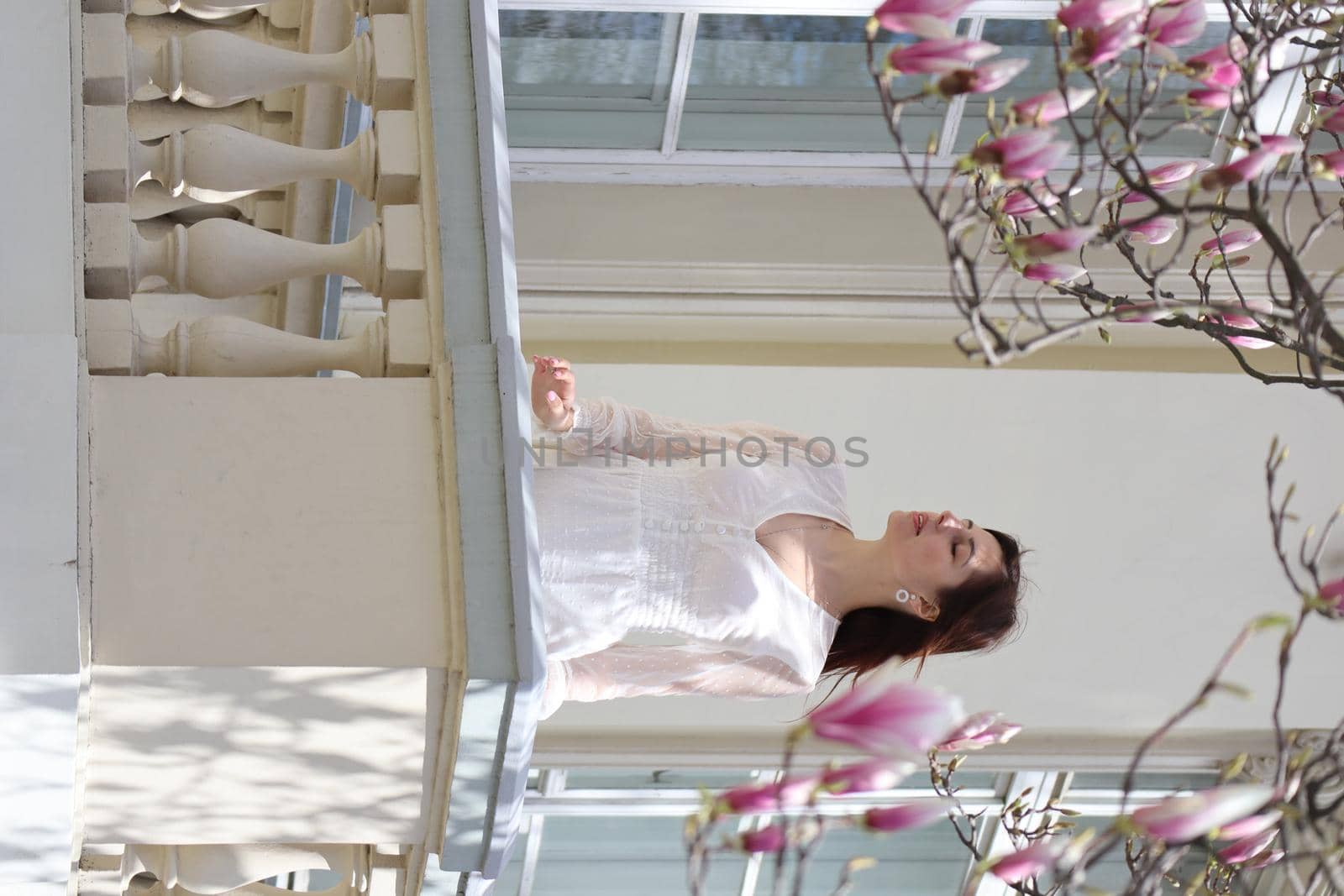 Beautiful brunette girl and blooming pink magnolias by Skywayua