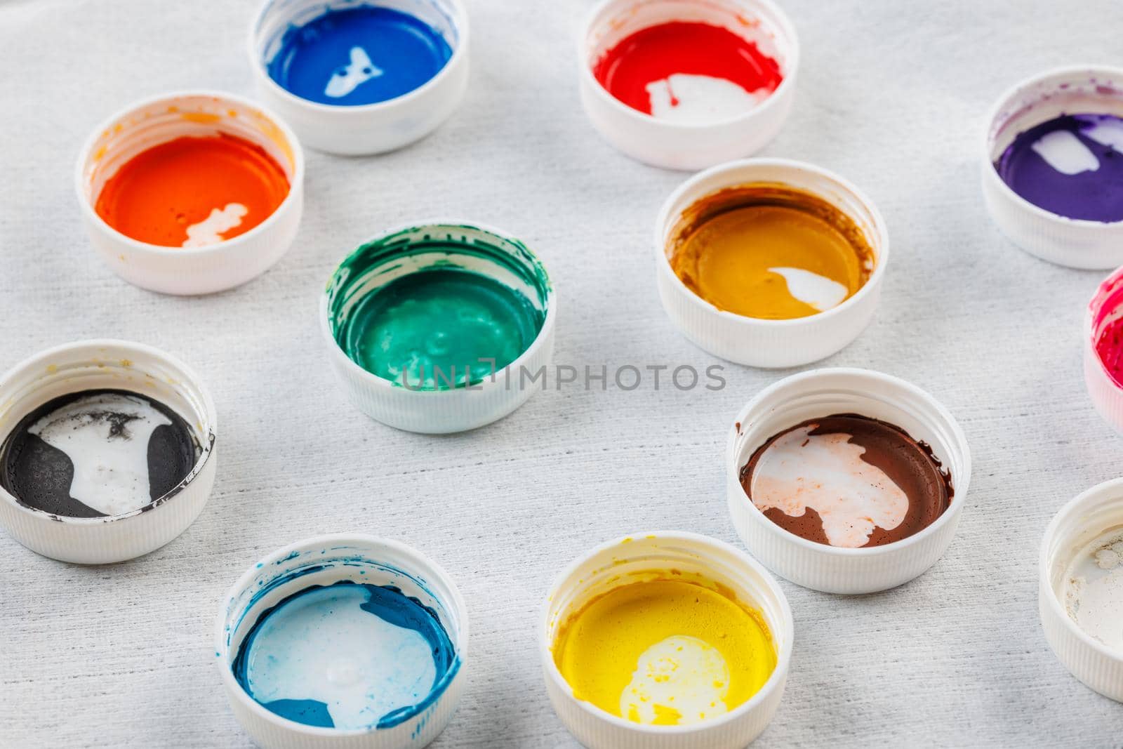 full-frame close-up background of gouache paint jar caps by z1b