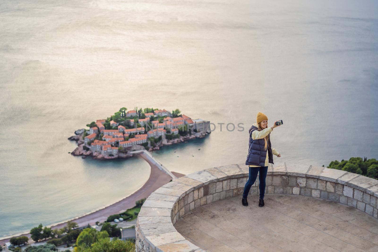 Woman tourist on background of beautiful view of the island of St. Stephen, Sveti Stefan on the Budva Riviera, Budva, Montenegro. Travel to Montenegro concept by galitskaya