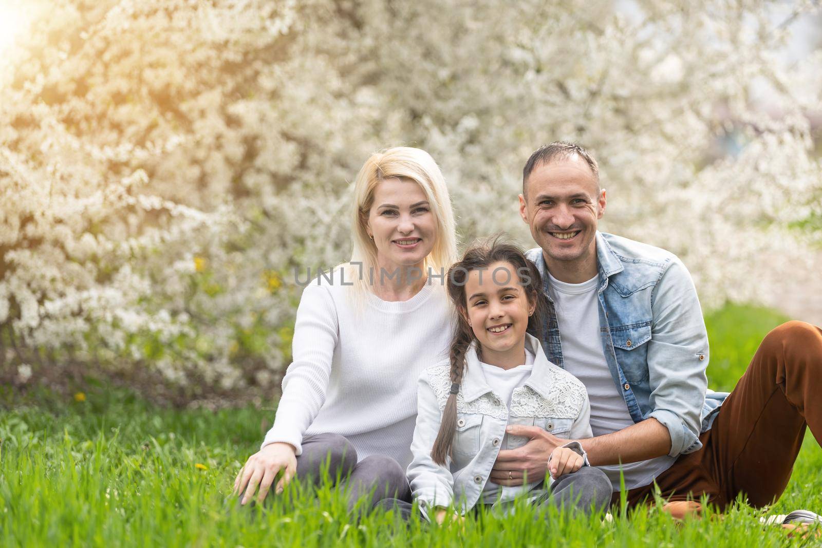 Happy family having picnic in nature. Smiling family picnicking in the park. spring nature by Andelov13