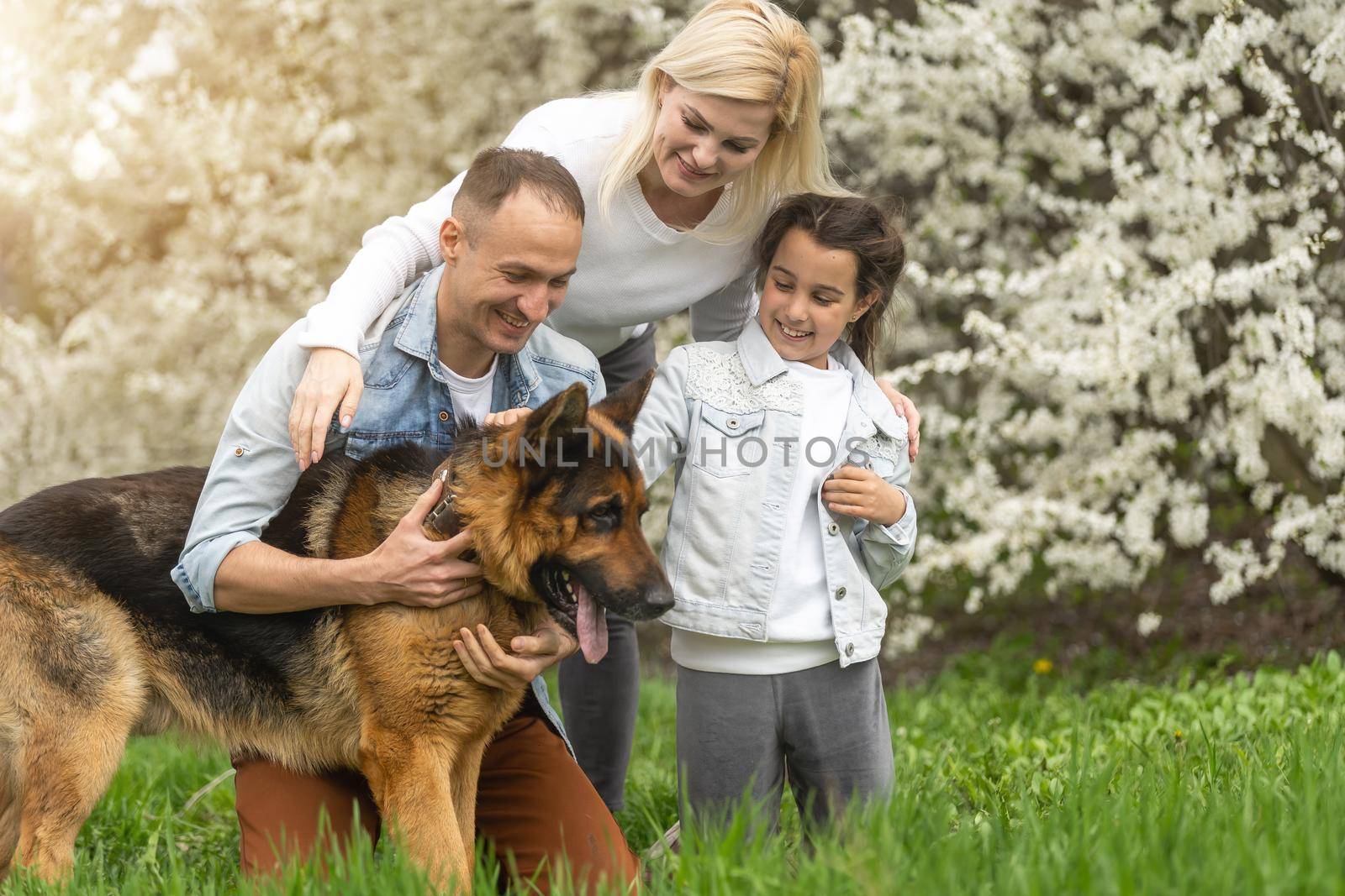 Family and small child outdoors in spring nature, resting