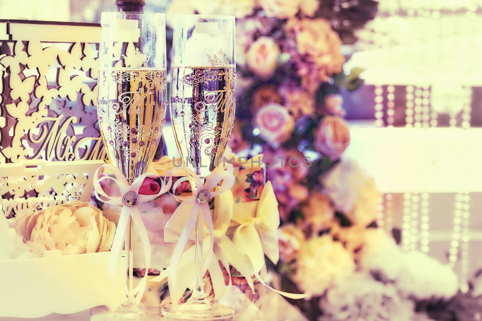 Two glasses of champagne in a festive wedding decoration by jovani68