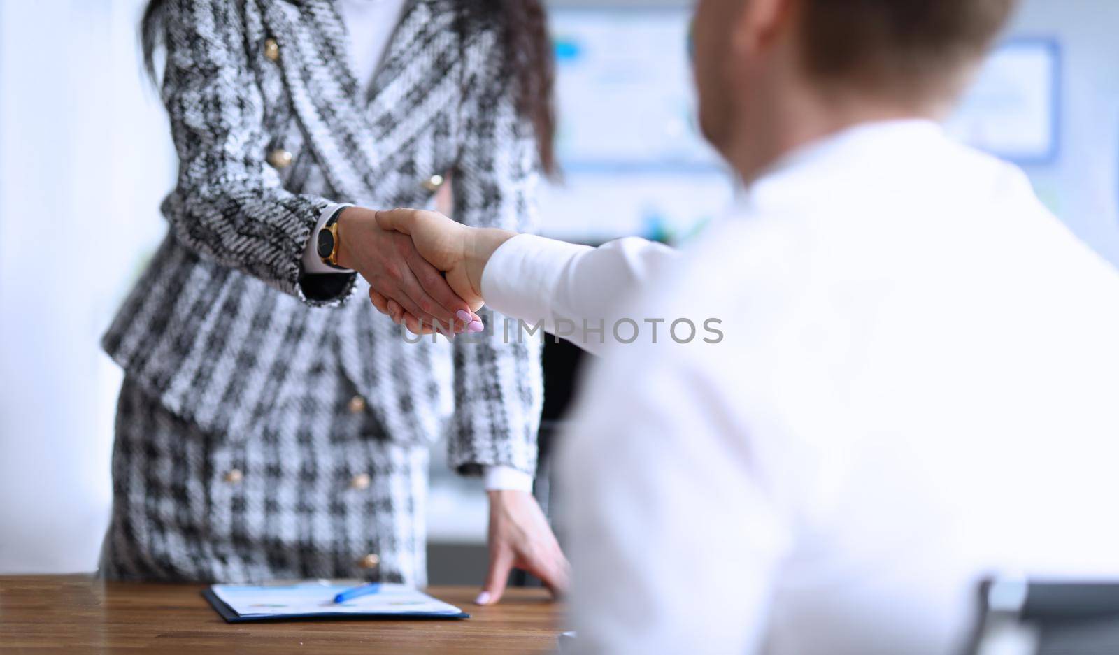 Close-up of business partners shaking hands after making good deal. Colleagues handshaking after bargaining or successful agreement. Contract concept