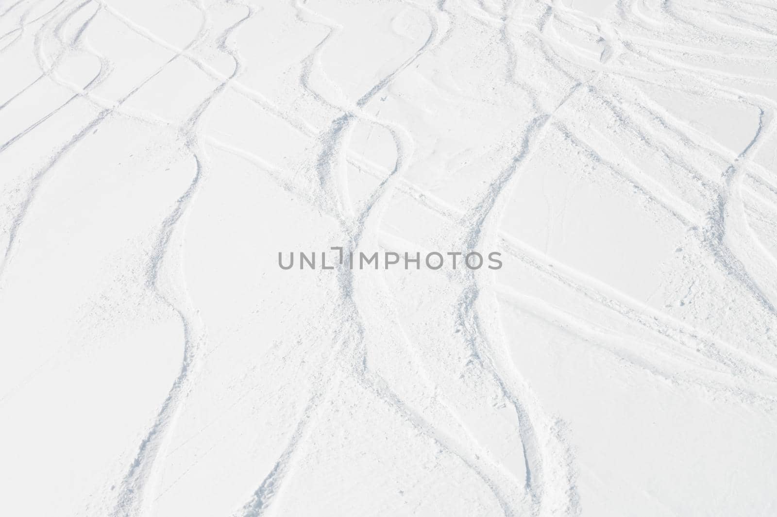 Curly ski trail on the snow in the mountains of Antarctica. Freeride off-piste skiing concept.