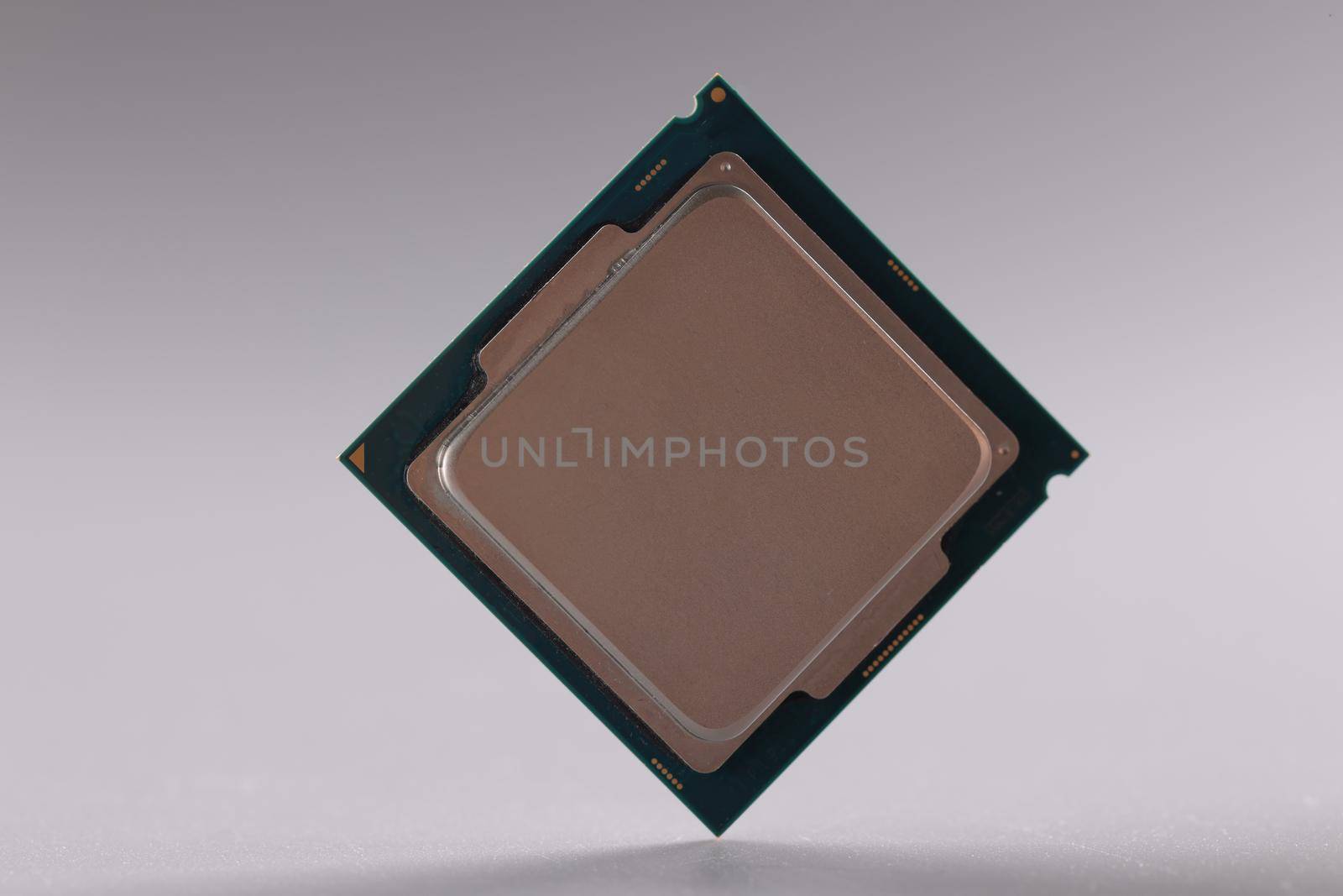 Close-up of central processing unit, processor chip on grey background. Chipping and microcircuits, modern technology and innovation concept