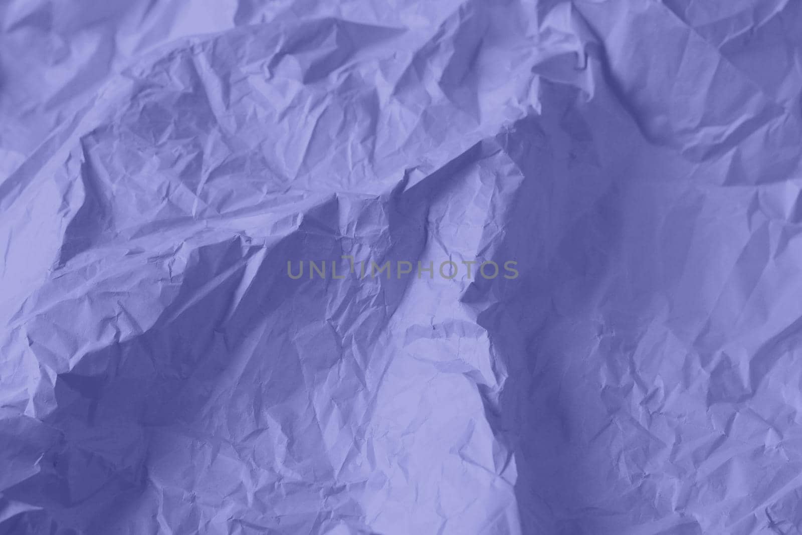 Crumpled paper Very Peri color of the year 2022. Texture crumpled paper for your design. Copy space. Very Peri color paper. High quality photo