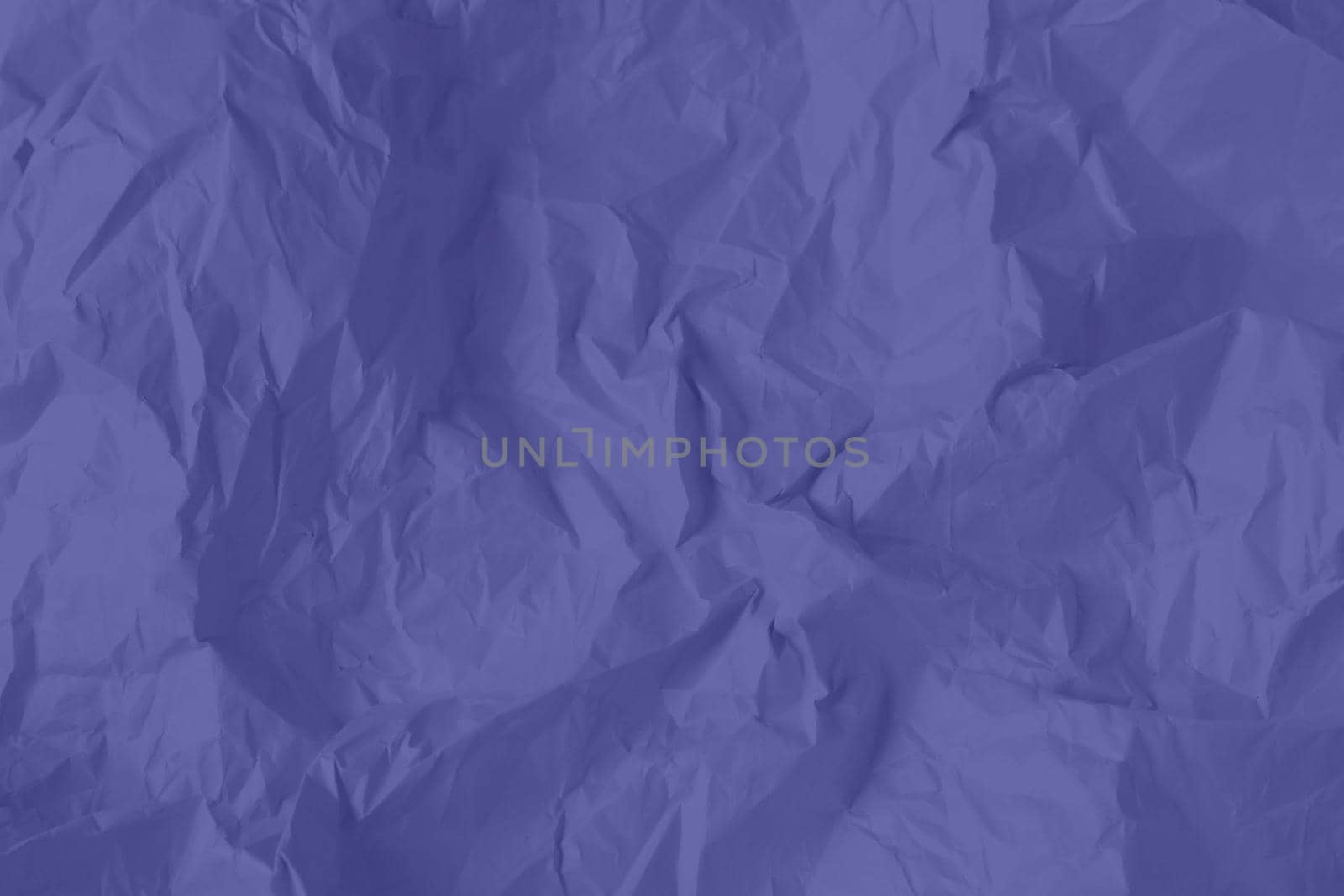 Crumpled paper Very Peri color of the year 2022. Texture crumpled paper for your design. Copy space. Very Peri color paper. High quality photo