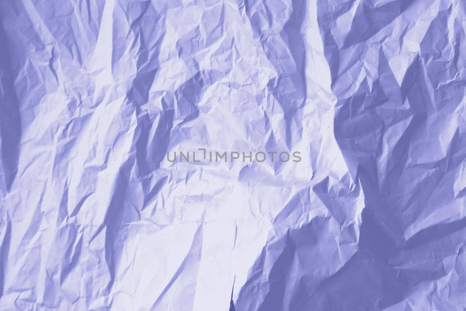 Crumpled paper Very Peri color of the year 2022. Texture crumpled paper for your design. Copy space. Very Peri color paper. High quality photo