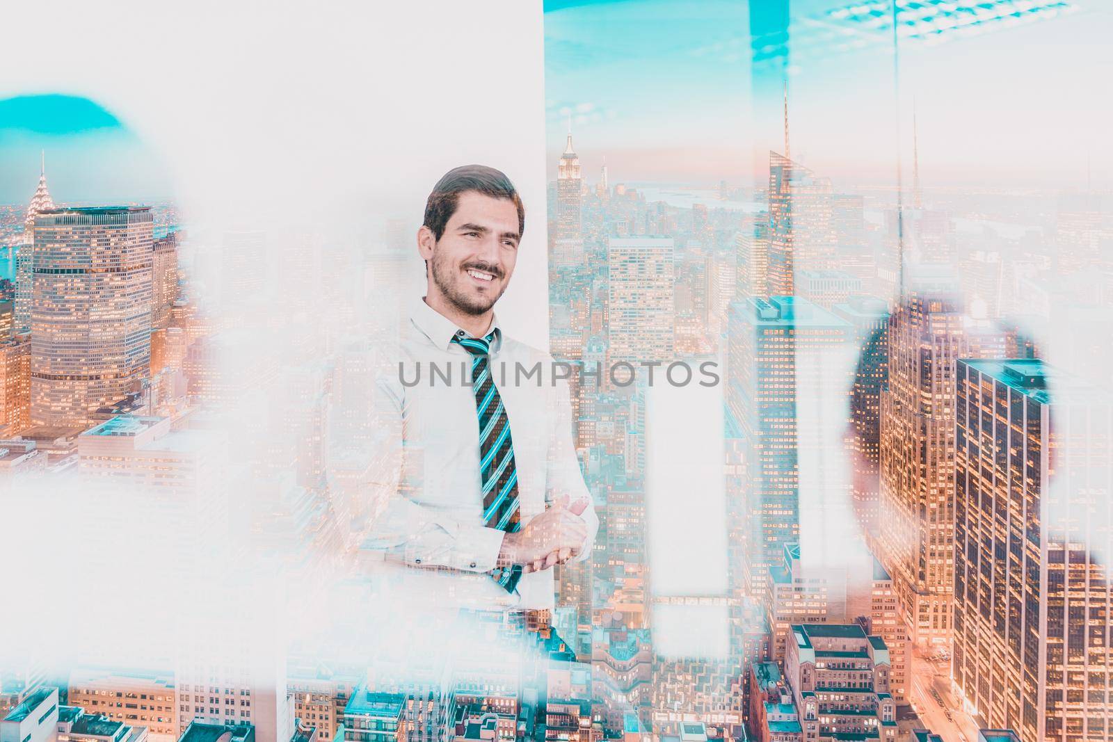 Relaxed cheerful team leader and business owner leading informal in-house business meeting. Business and entrepreneurship concept. New Your city lights reflection in window glass.