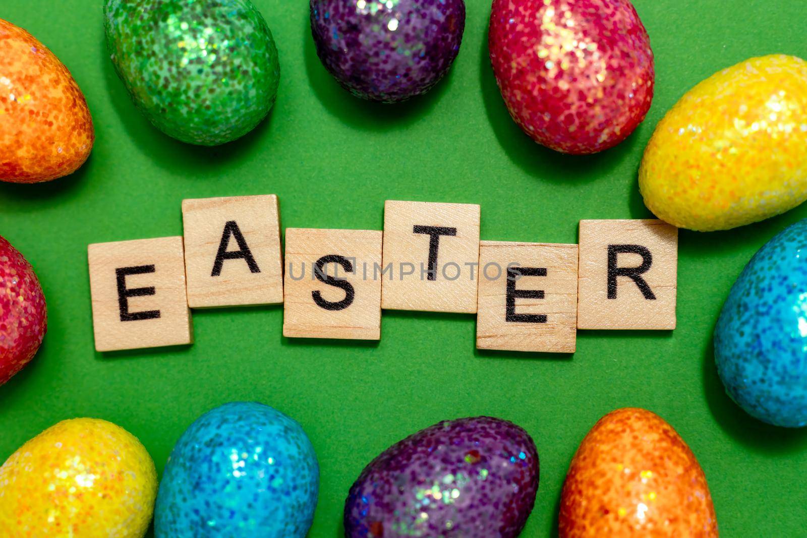 Easter card with eggs on a green background and the inscription Easter. Easter spring break concept.