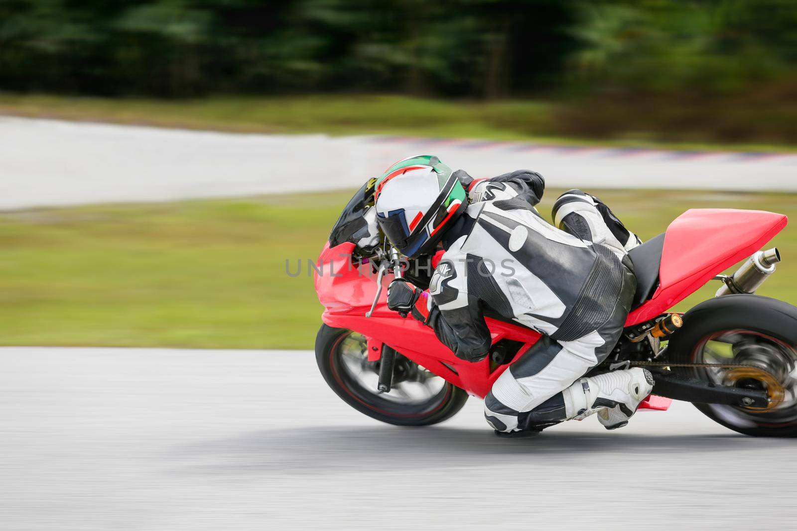 Motorcycle practice leaning into a fast corner on track