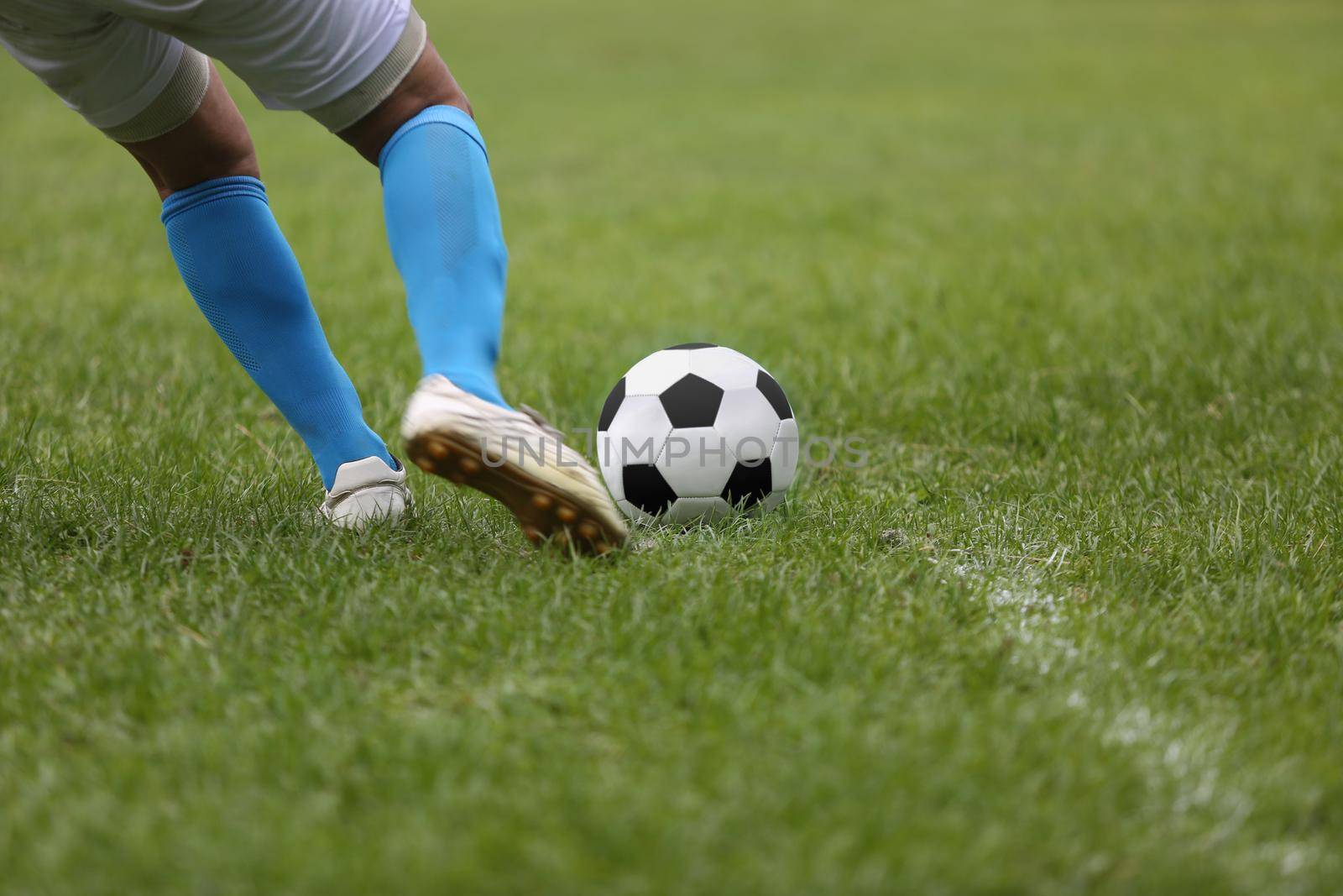 Close up of a football  with player  kicking the ball