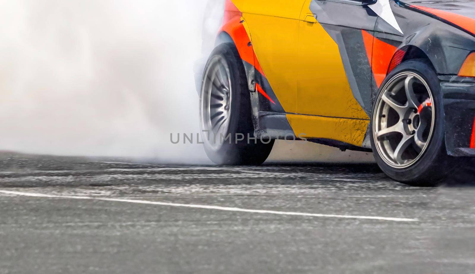 Race drift car burning tires on speed track