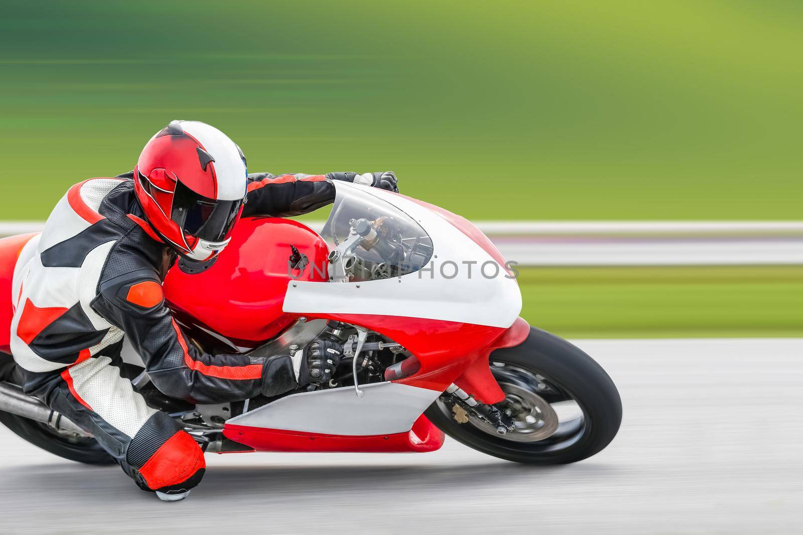 Motorcycle practice leaning into a fast corner on track