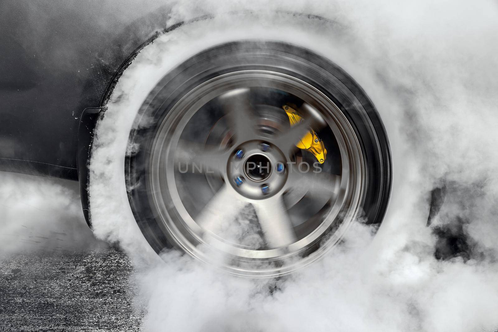 Drag racing car burns rubber off its tires in preparation for the race by toa55