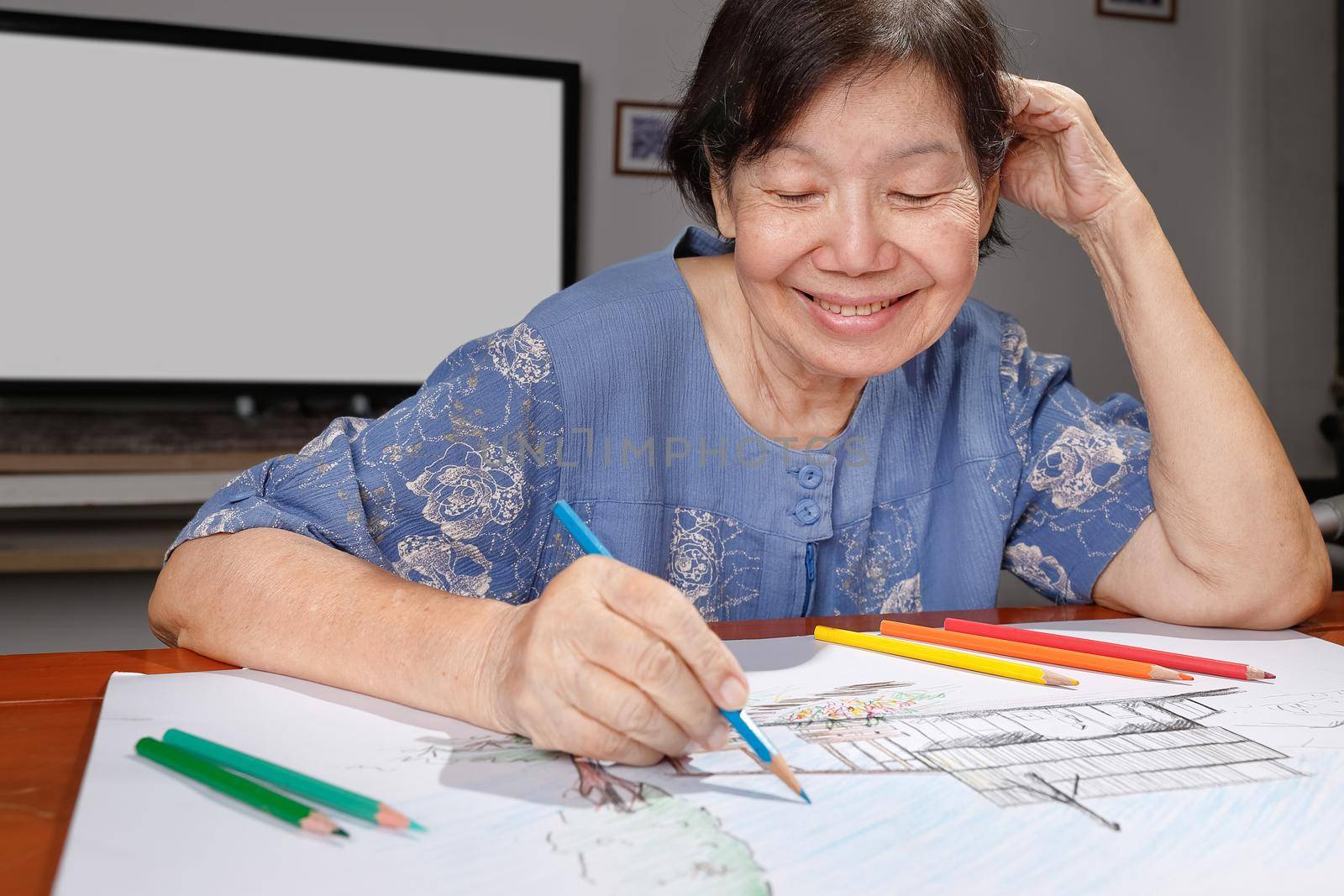 Elderly woman painting color on her drawing  , hobby at home by toa55