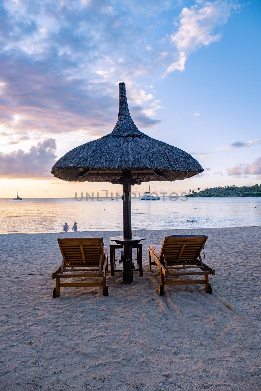 luxury travel, romantic beach getaway holidays for honeymoon couples, tropical vacations in a luxurious hotel, and beach chairs on the beach.