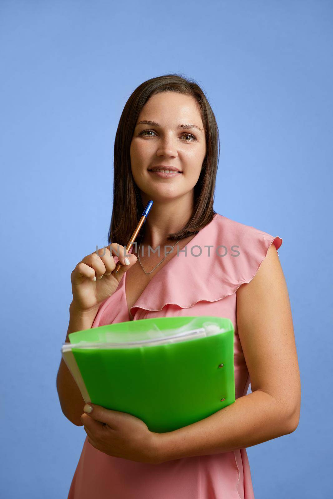 Caucasian young female teacher standing on a background