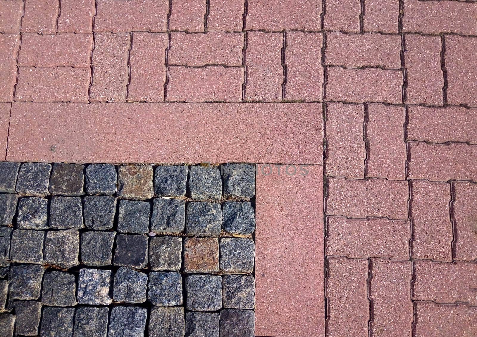 Rough pavement texture, old gray granite and red tiles.