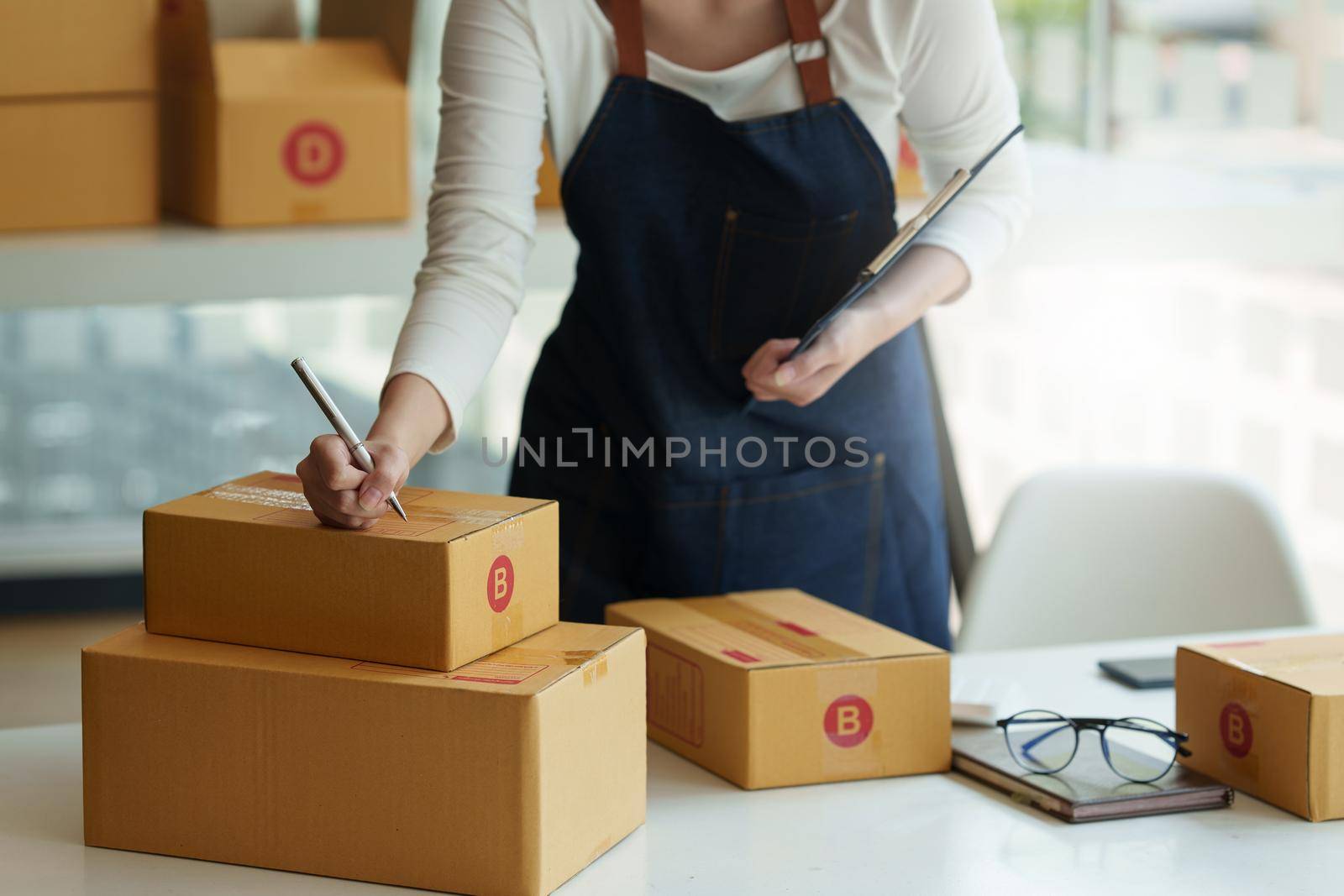 Asian small business owner working at home office. Business retail market and online sell marketing delivery, SME e-commerce concept. by itchaznong
